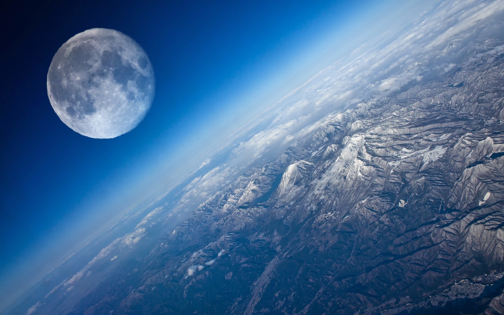 The Moon over snow-capped mountains from space HD Wallpaper
