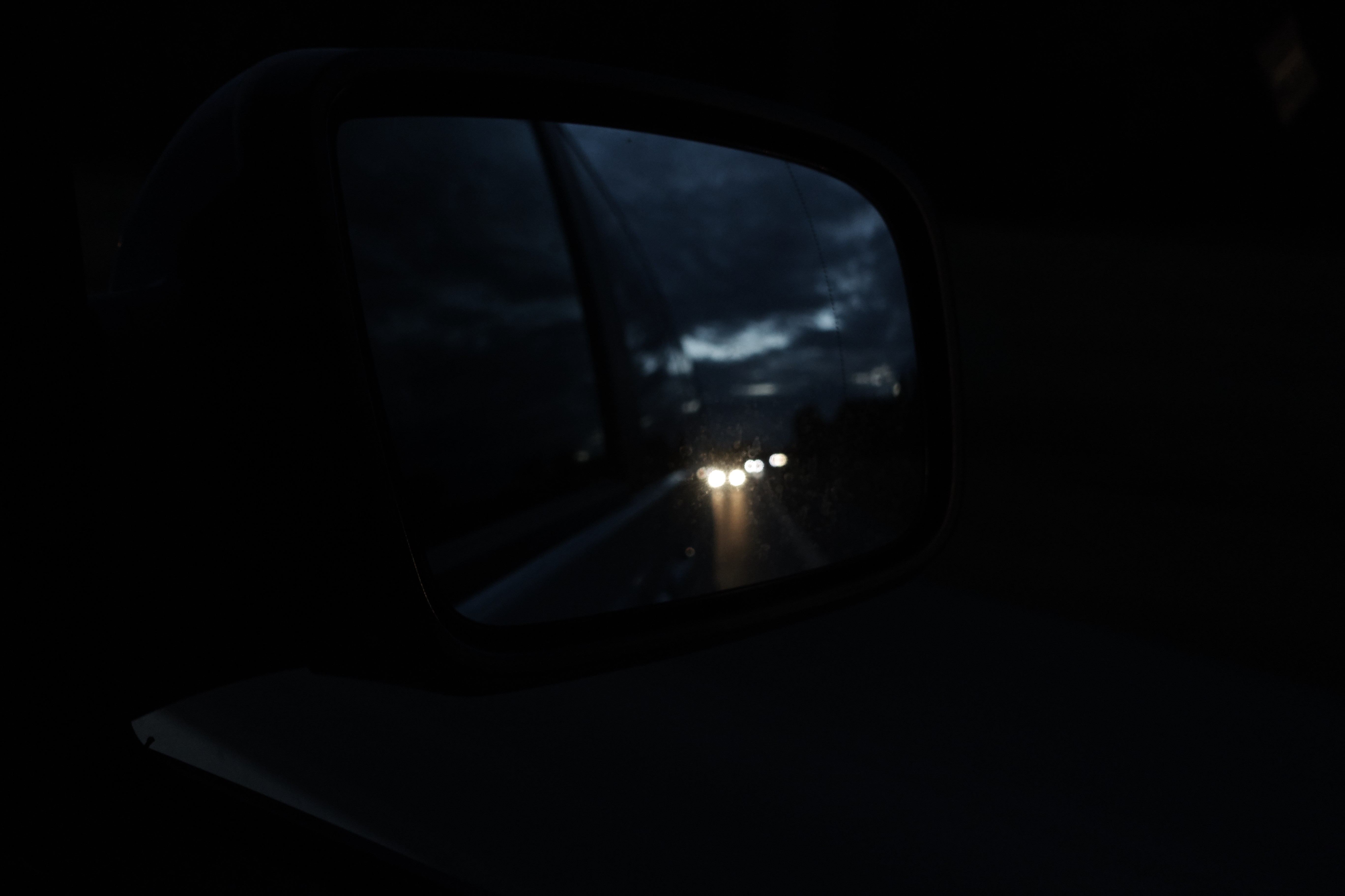 Car side mirror reflecting headlights at night HD Wallpaper