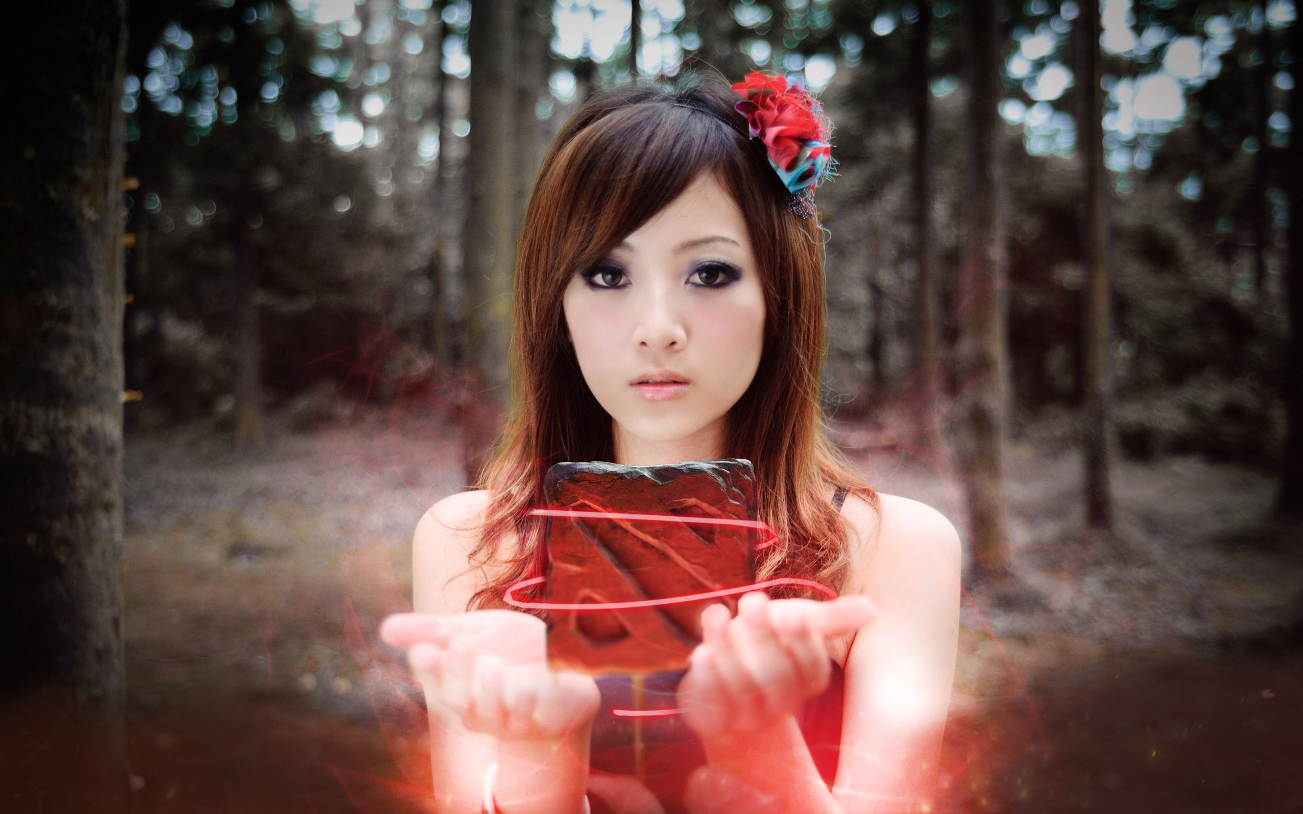 Asian woman holding a glowing red object in a forest HD Wallpaper