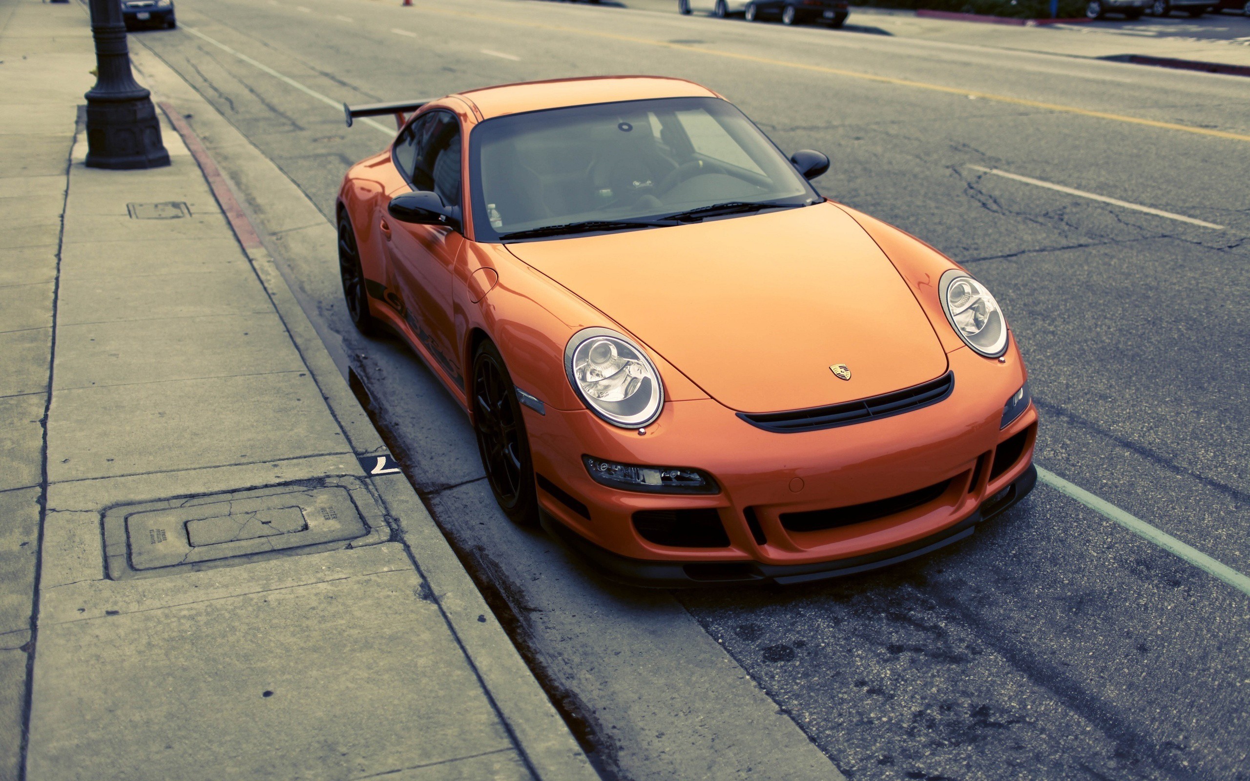 Orange Porsche 911 Carrera S parked on a street HD Wallpaper