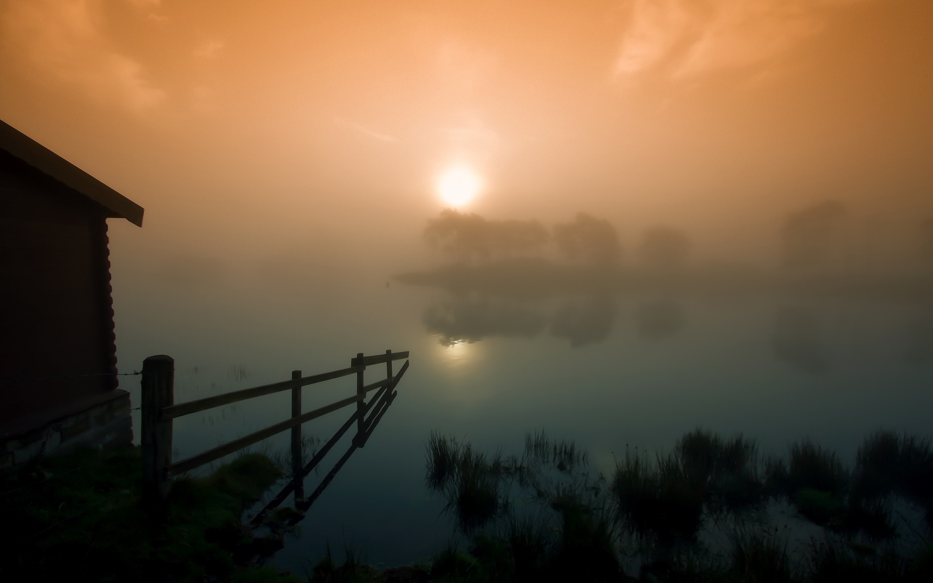 Misty sunrise over a lake with a wooden cabin HD Wallpaper