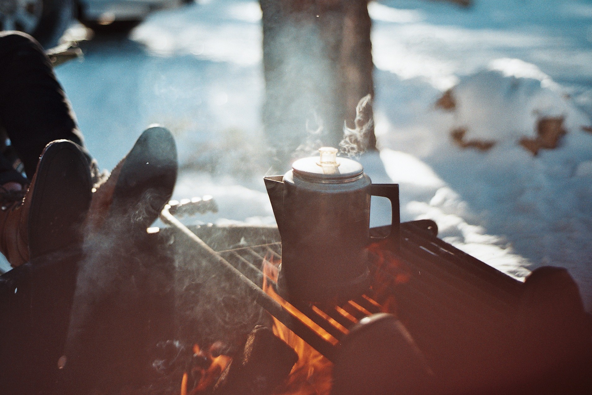 Percolator boiling on a campfire in the snow HD Wallpaper