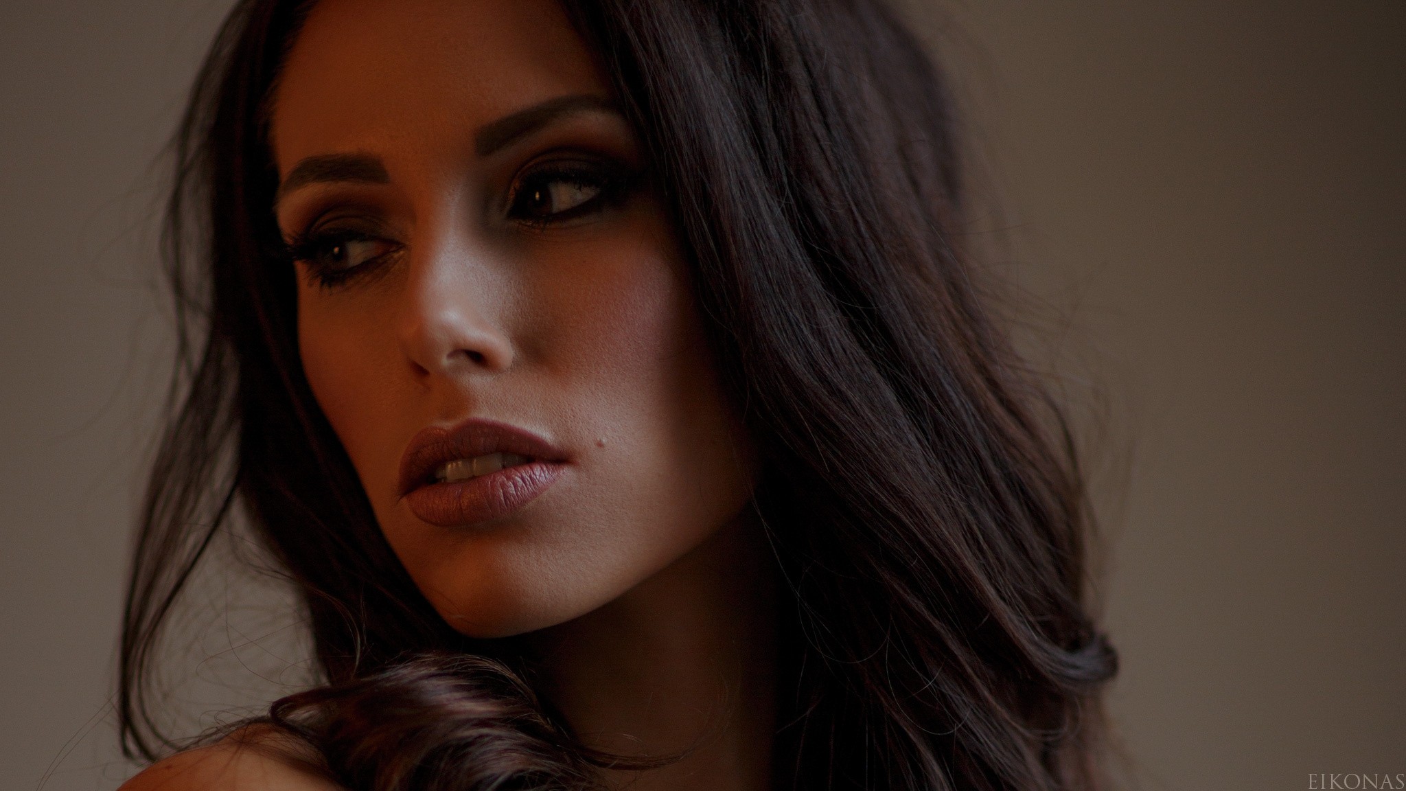 Woman with long dark hair and makeup HD Wallpaper