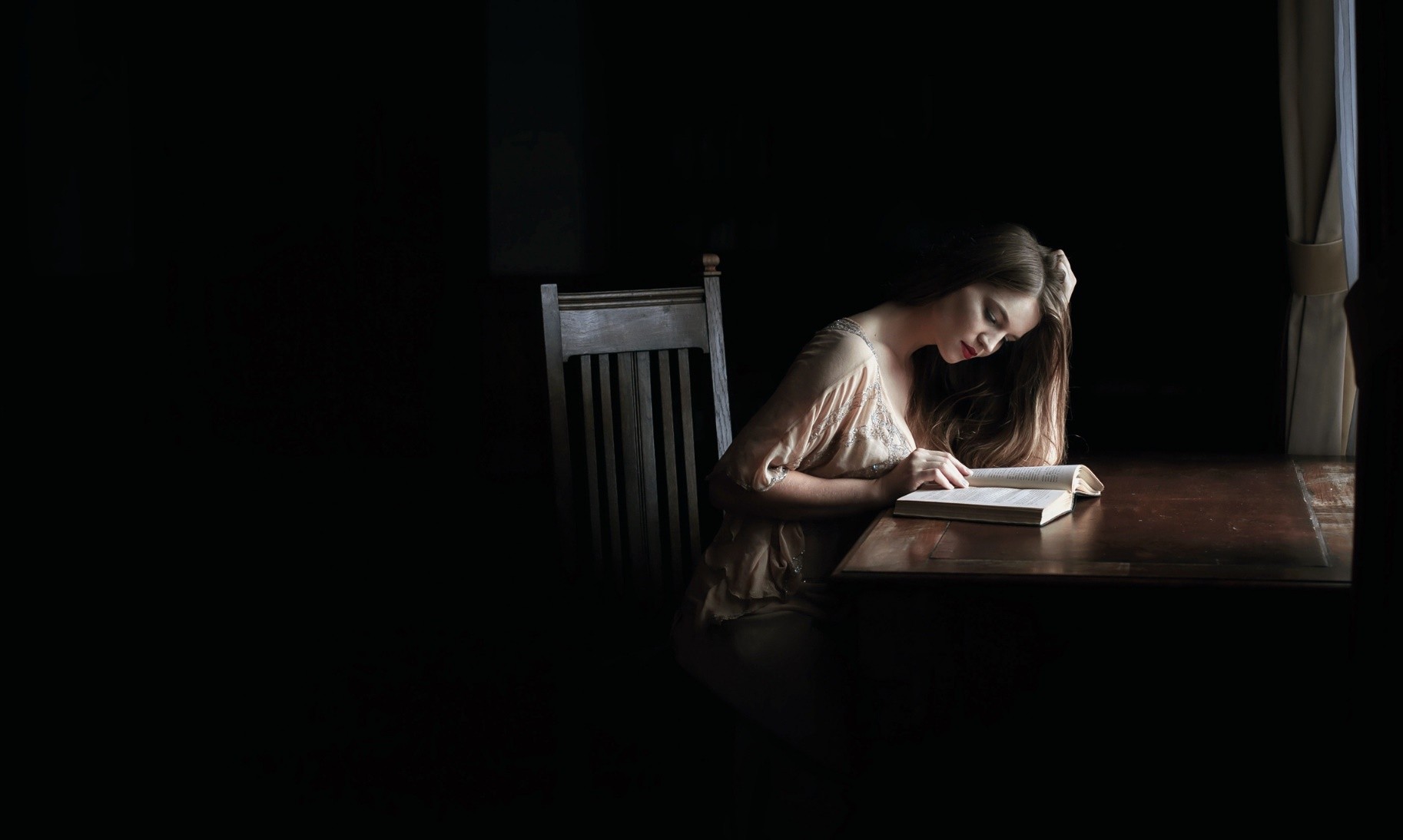 Woman reading a book at a table HD Wallpaper