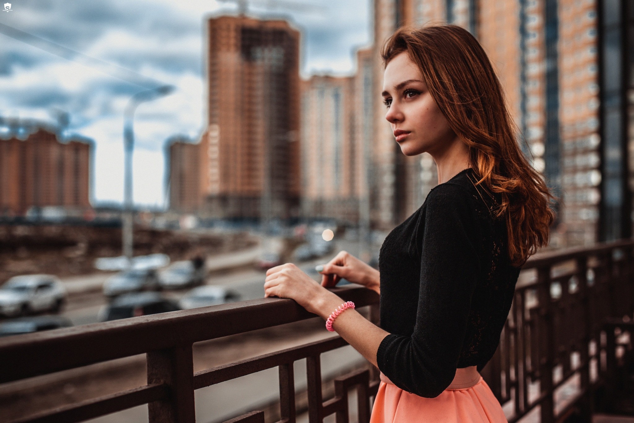 Woman with long wavy hair in a cityscape HD Wallpaper