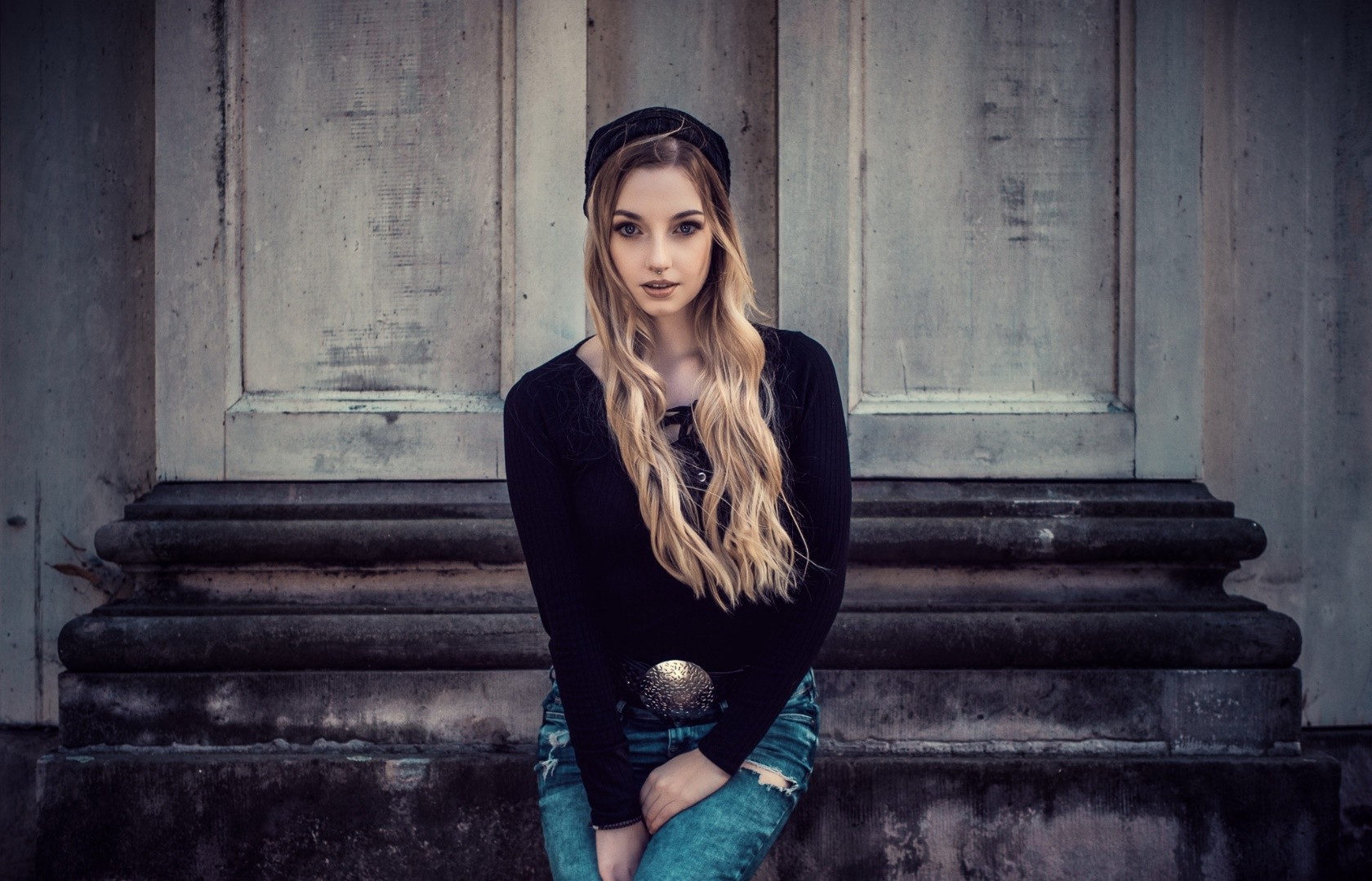 Woman with long blonde hair wearing a black top and jeans HD Wallpaper