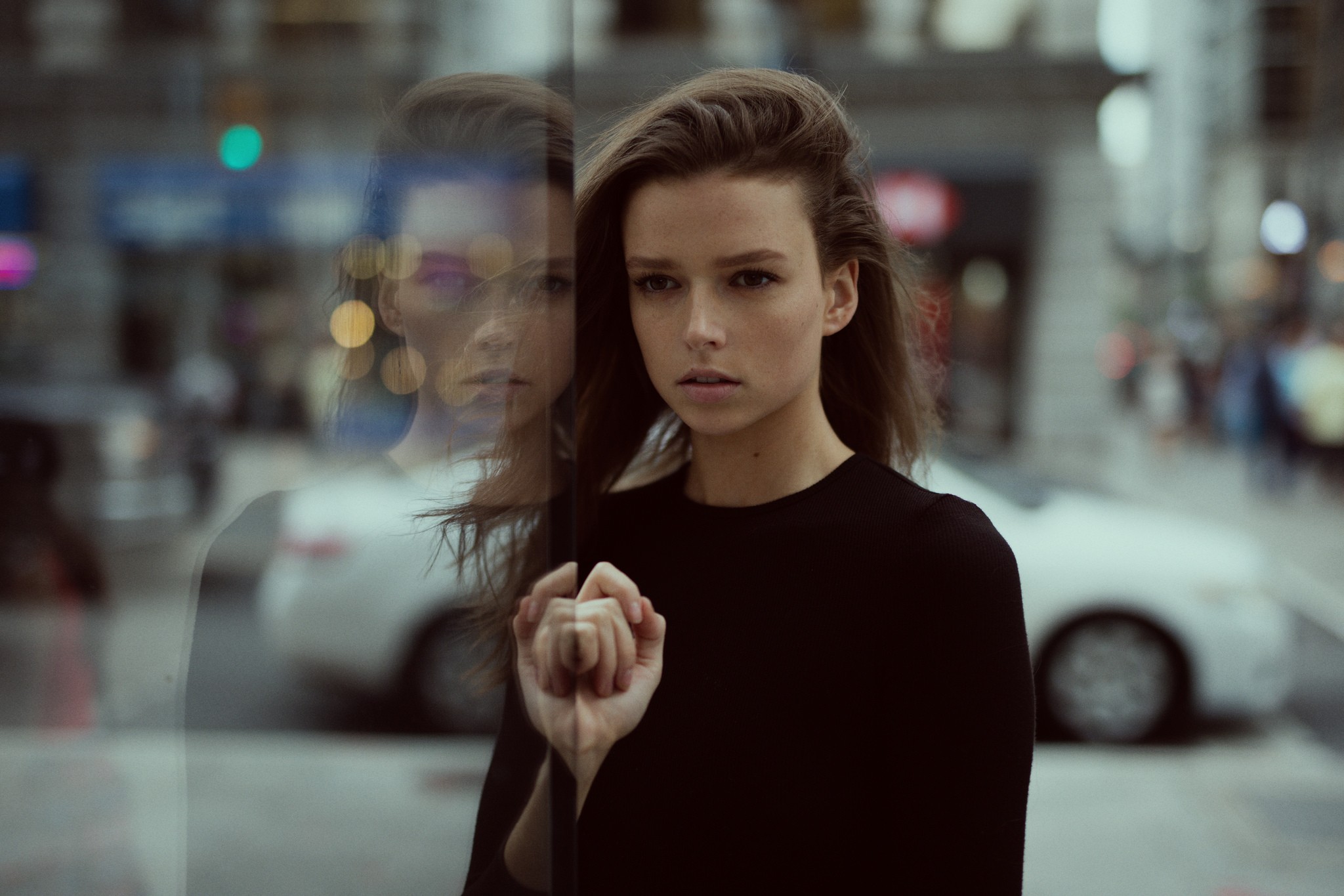 Jesse Herzog reflected in glass on a city street HD Wallpaper