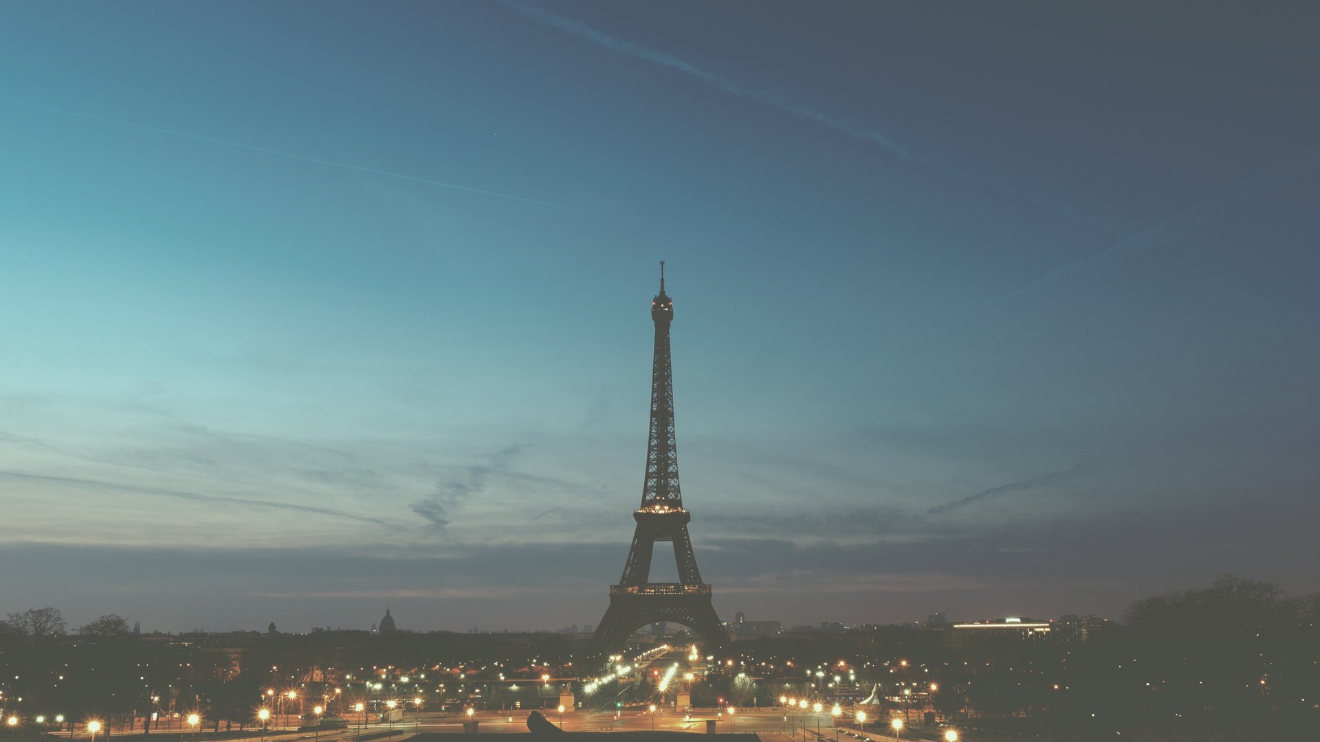 Eiffel Tower at dusk with city lights HD Wallpaper