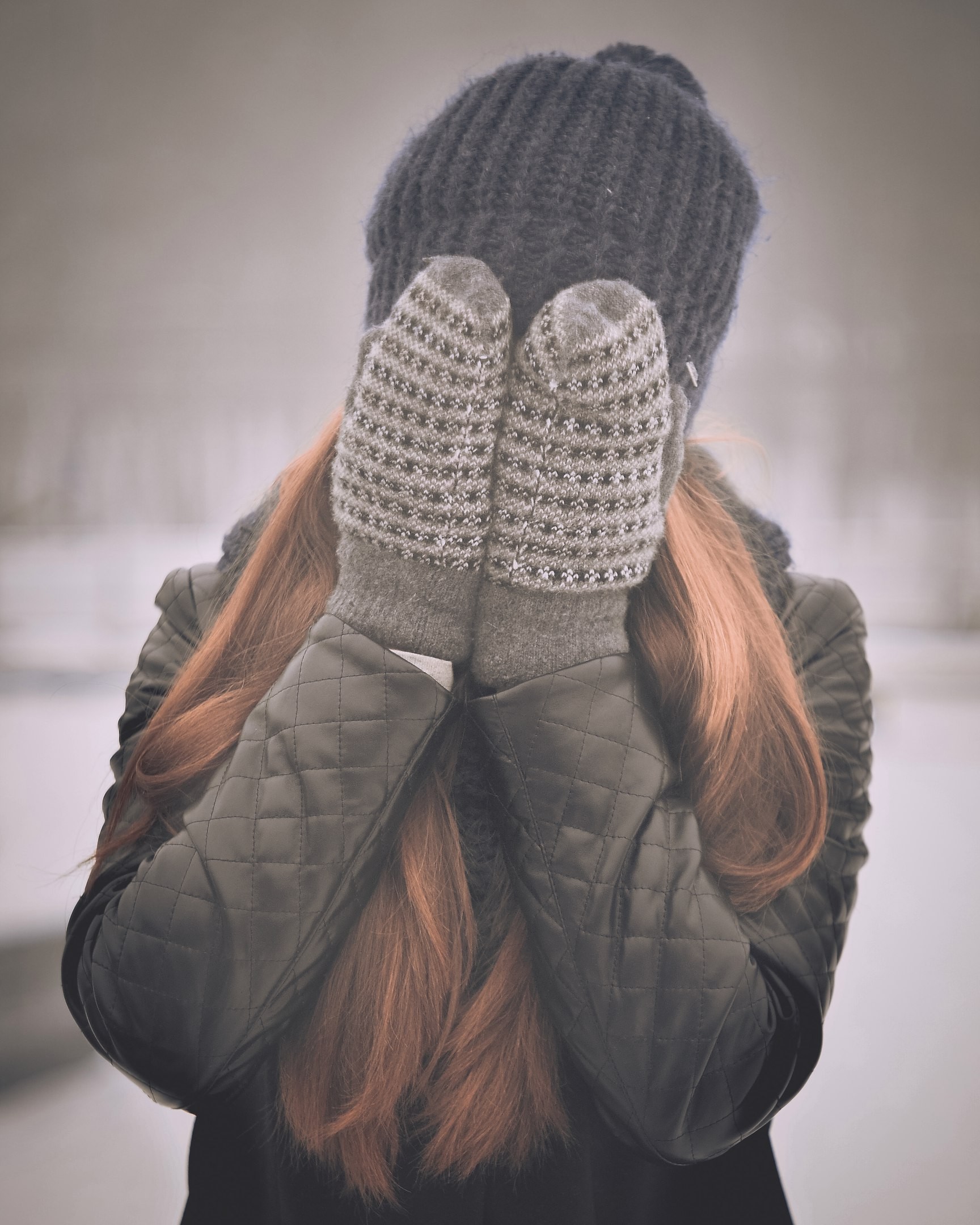 Woman in winter hat and mittens covering face HD Wallpaper