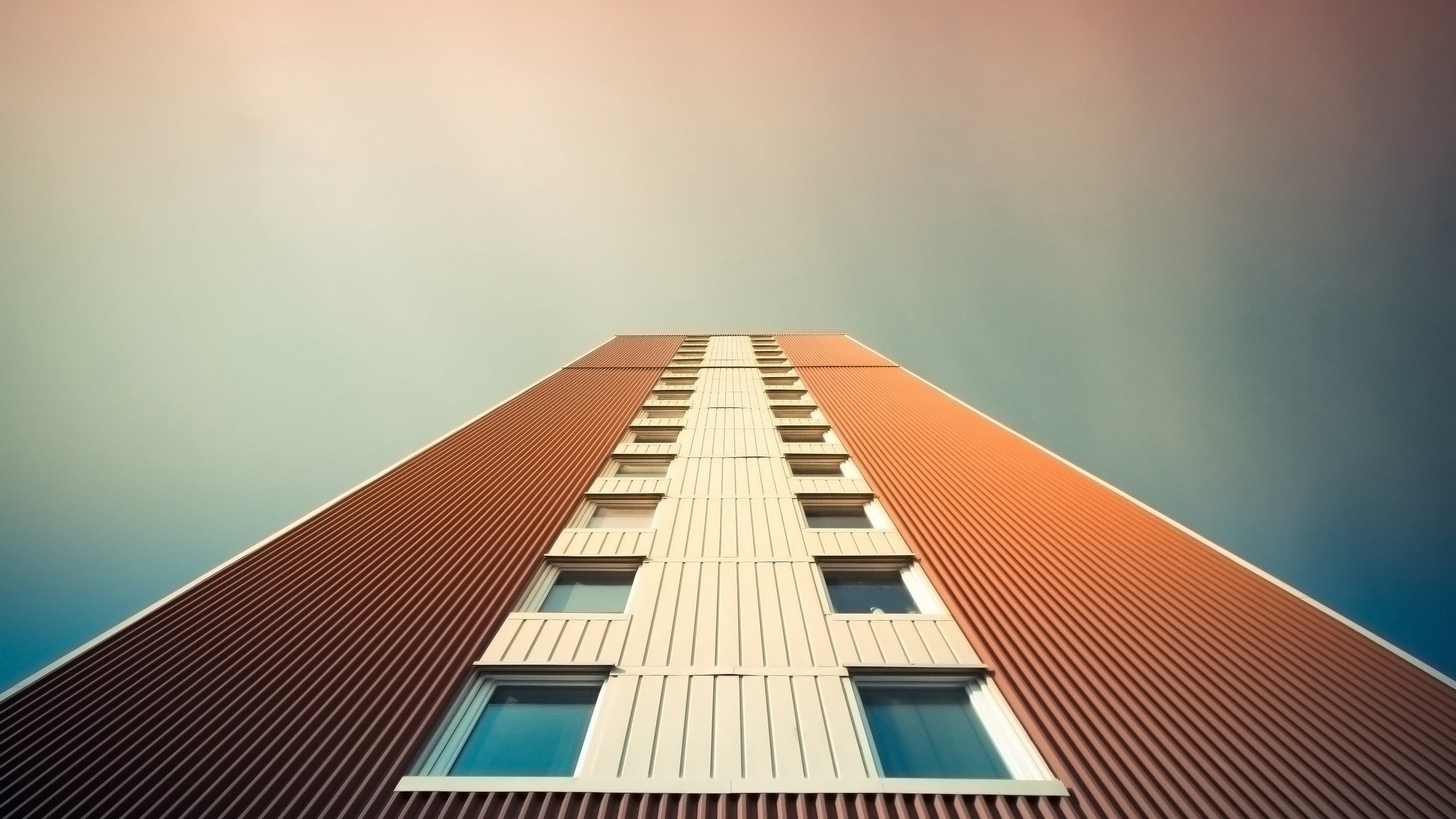 Worm's eye view of a tall building with windows HD Wallpaper