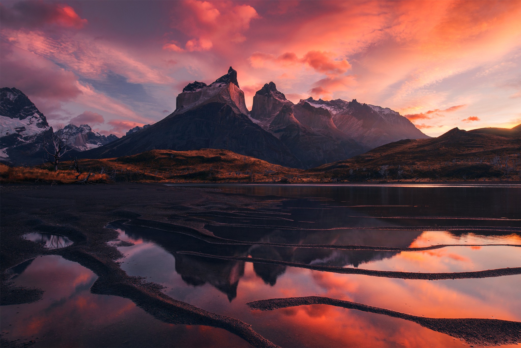 Torres del Paine mountains reflected in a lake at sunset HD Wallpaper
