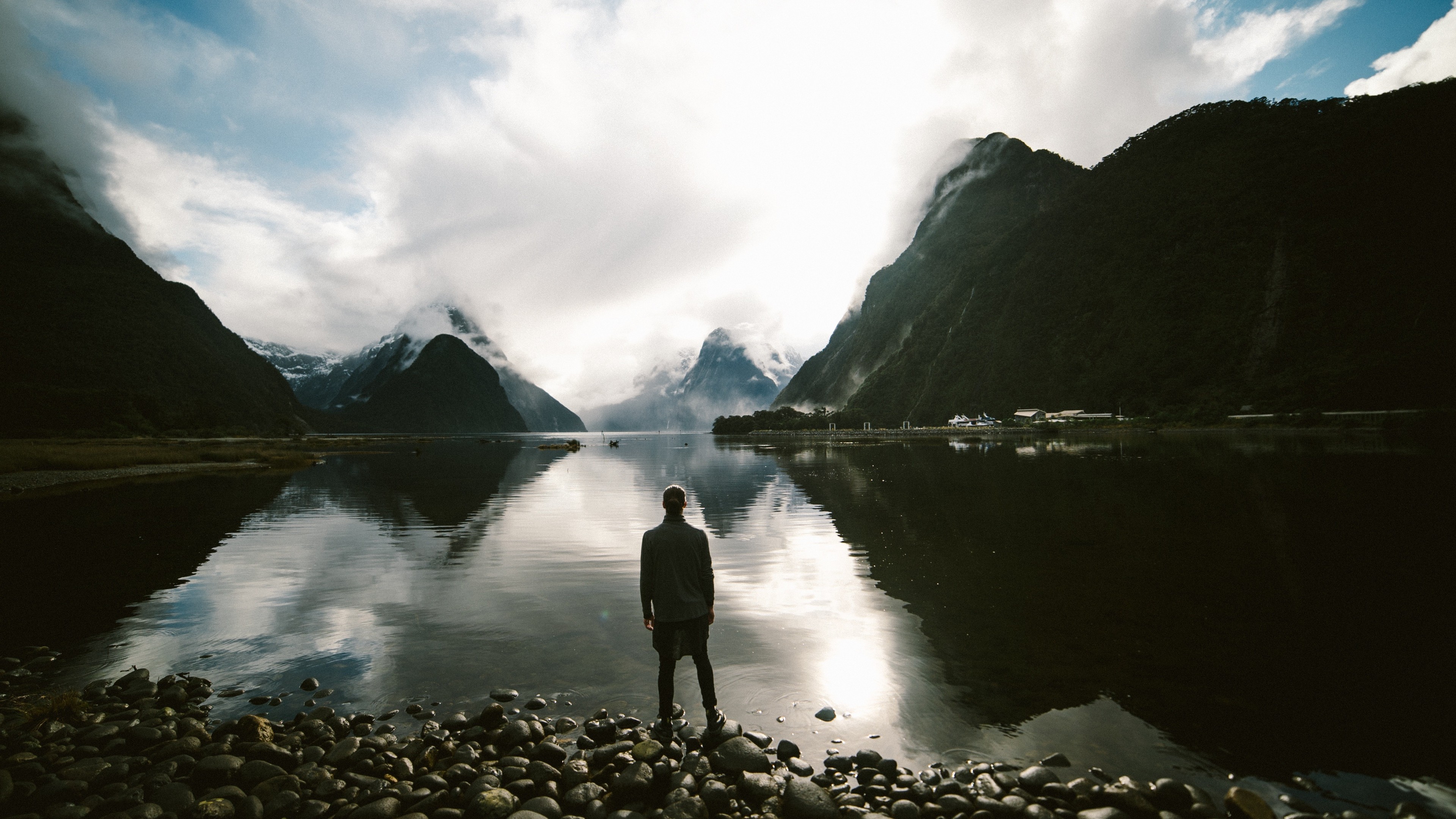 Man standing at Milford Sound, New Zealand HD Wallpaper