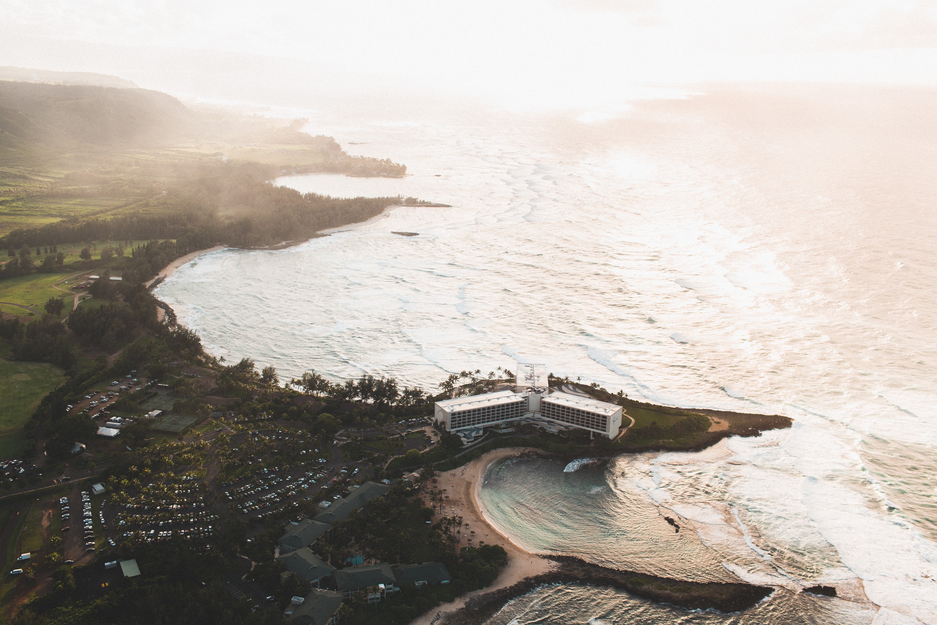 Aerial view of a resort on a coastline with ocean waves HD Wallpaper