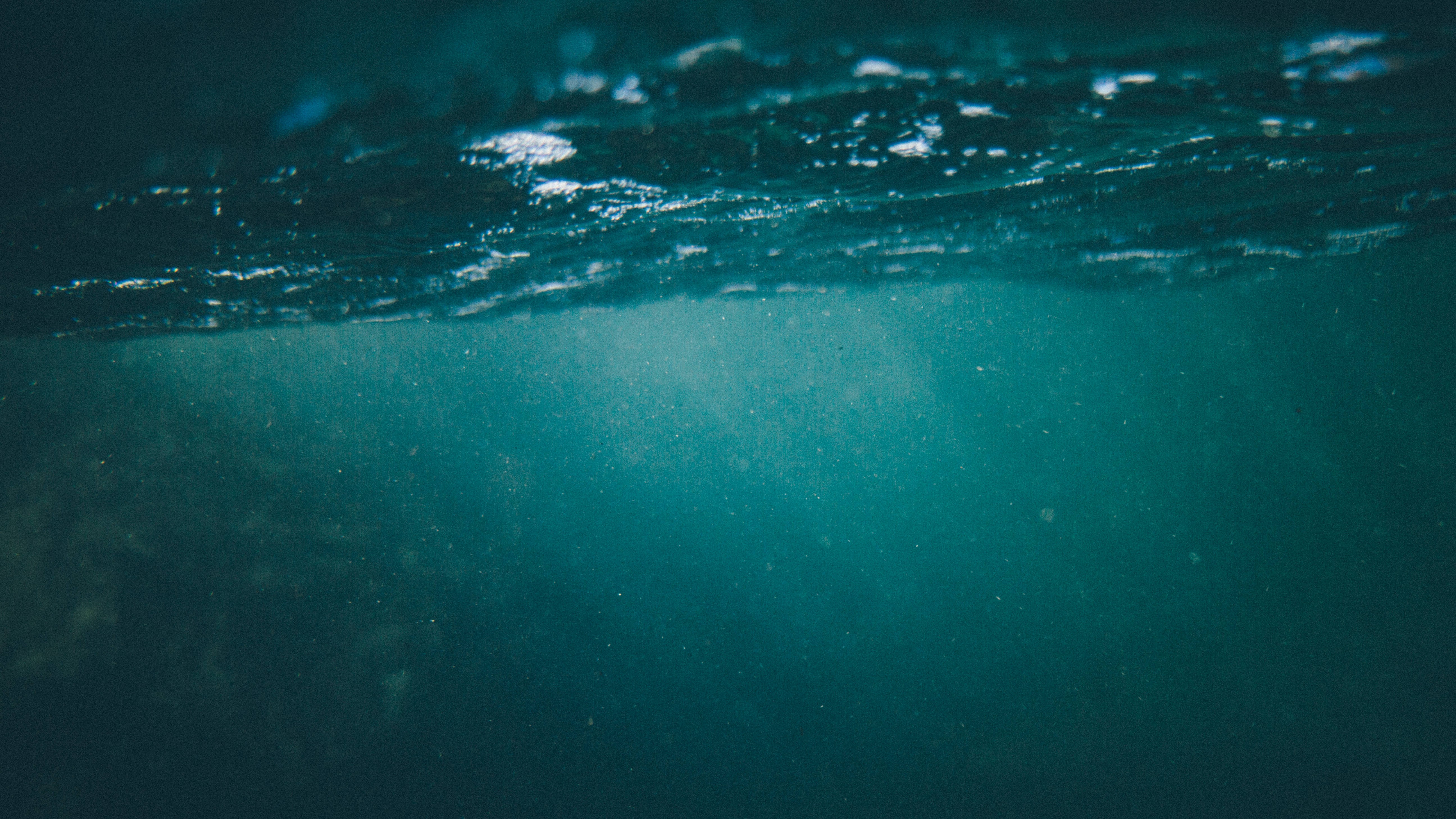 Underwater view of the ocean surface with light rays HD Wallpaper
