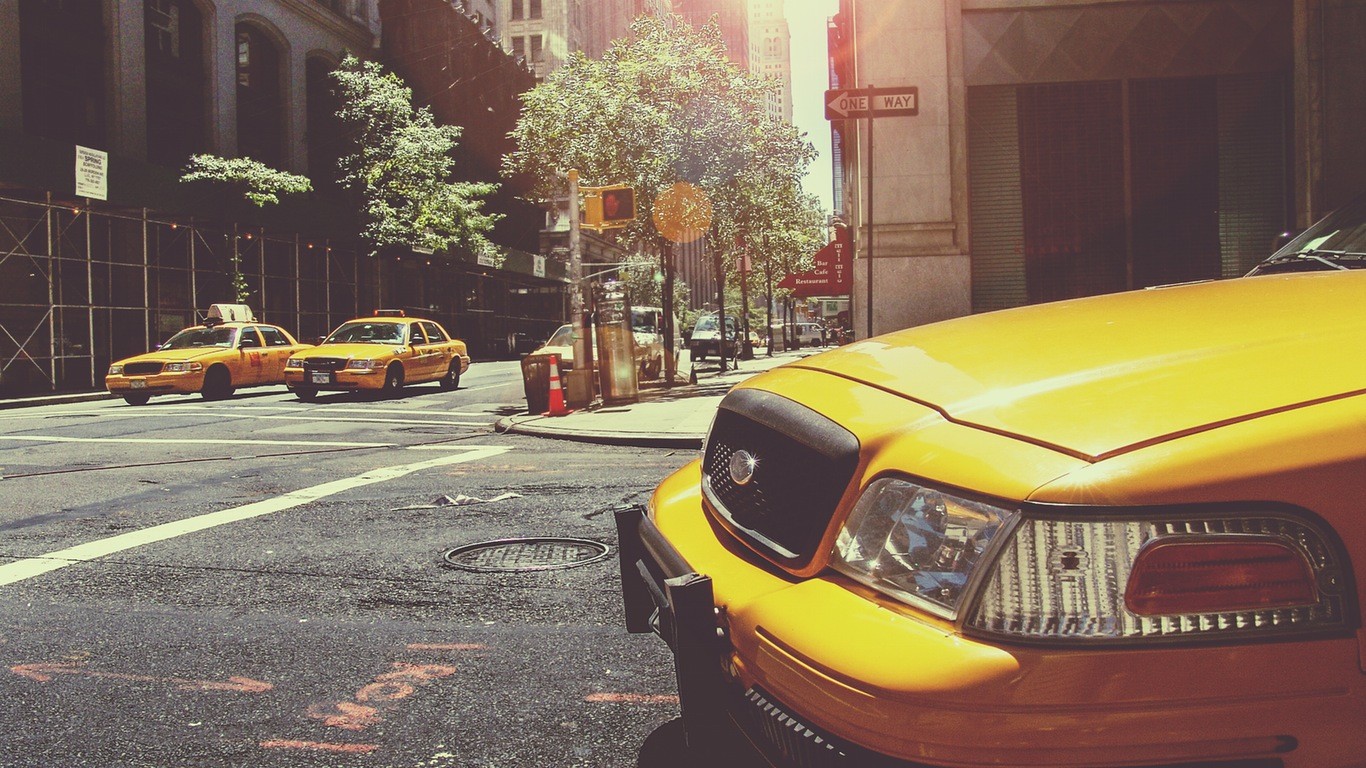 Yellow taxis on a city street HD Wallpaper