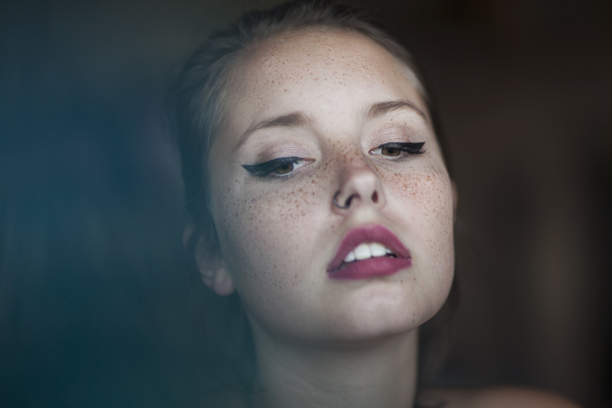 Woman with freckles and winged eyeliner HD Wallpaper
