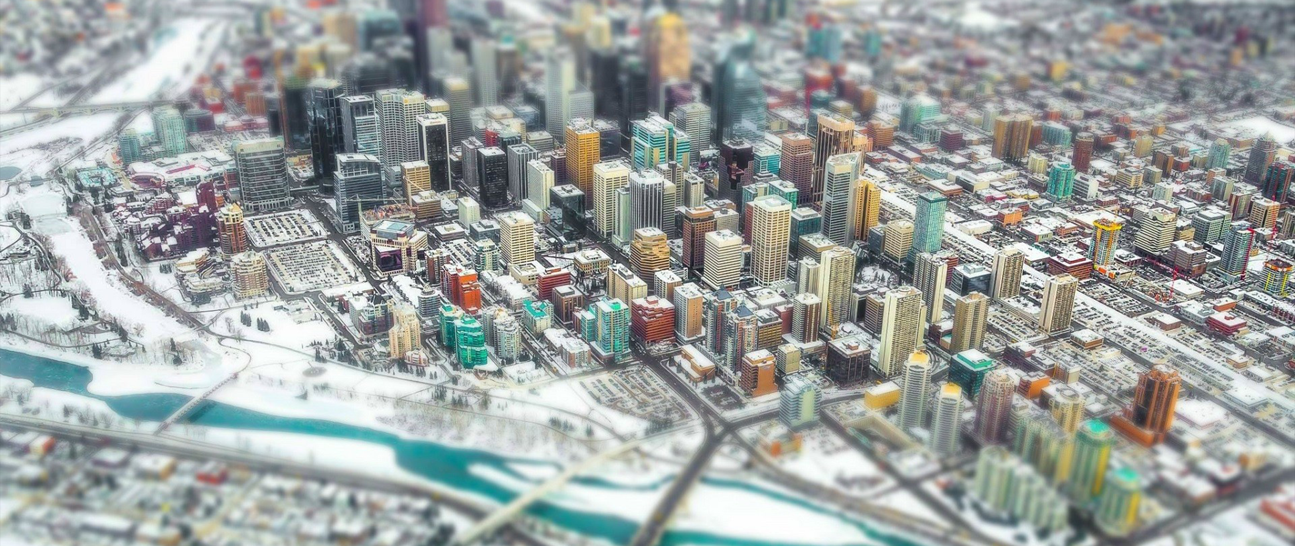 Aerial tilt-shift photography of a snowy city skyline HD Wallpaper