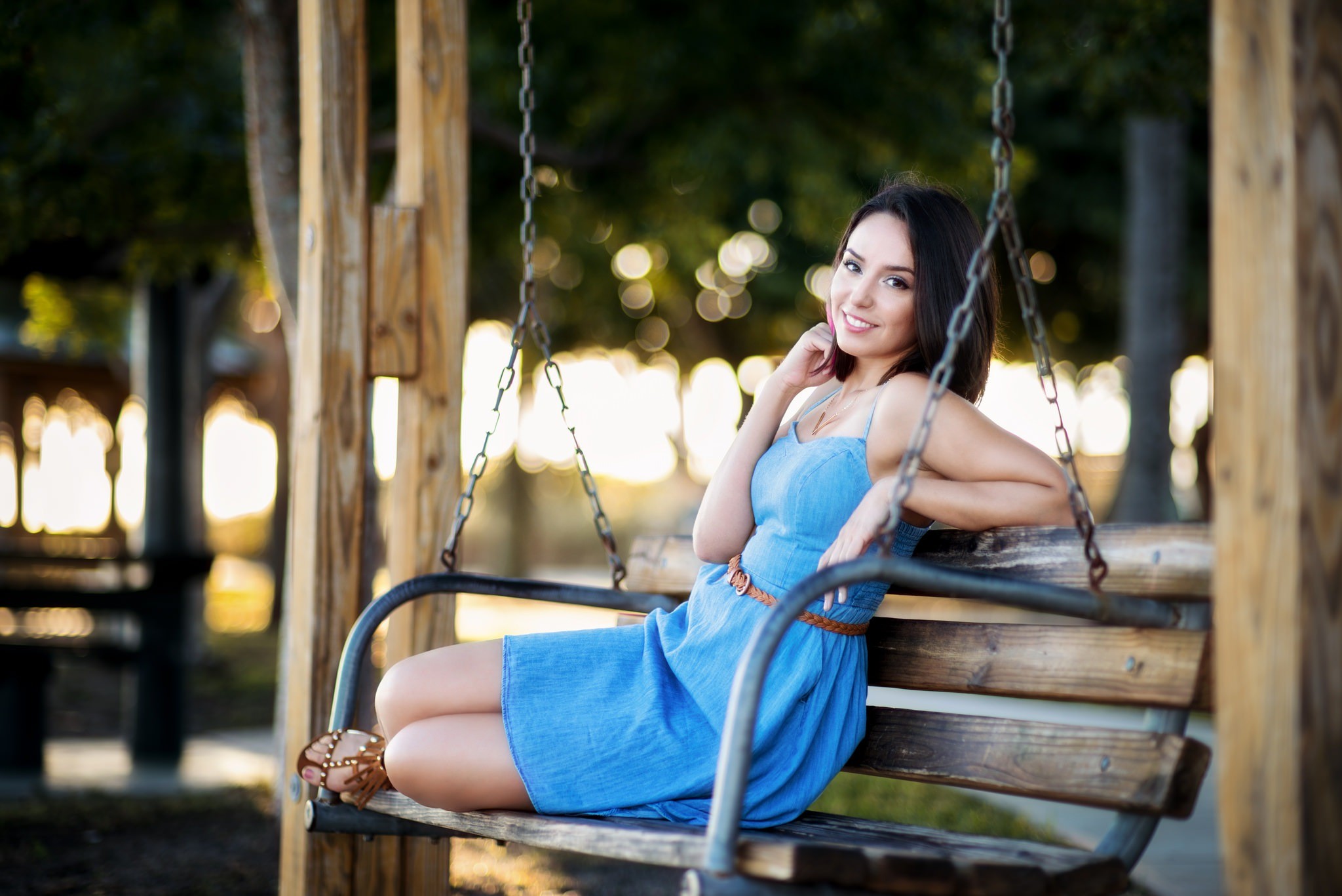 Woman in blue dress sitting on a swing HD Wallpaper