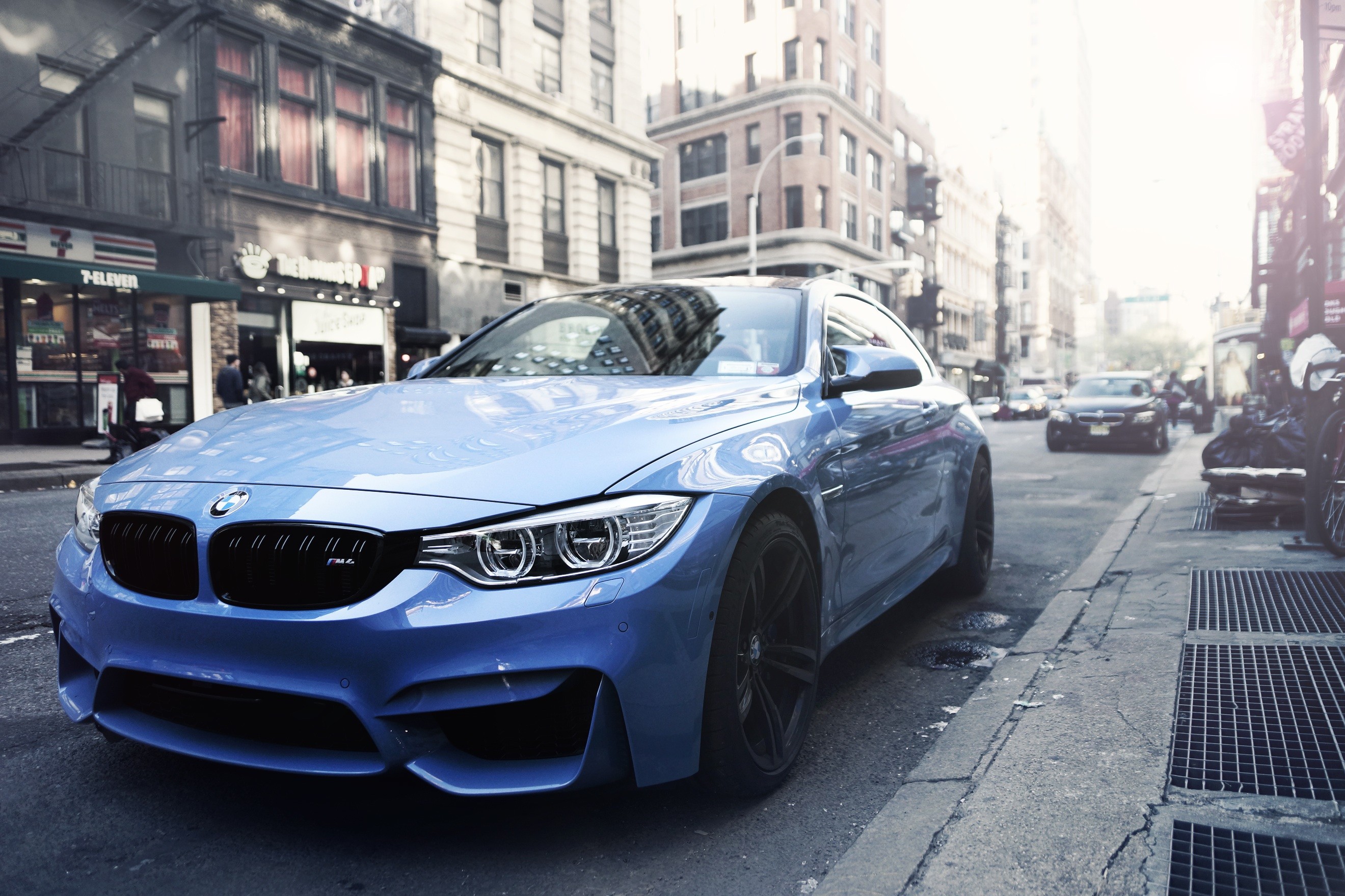Blue BMW M4 Coupe parked on a city street HD Wallpaper