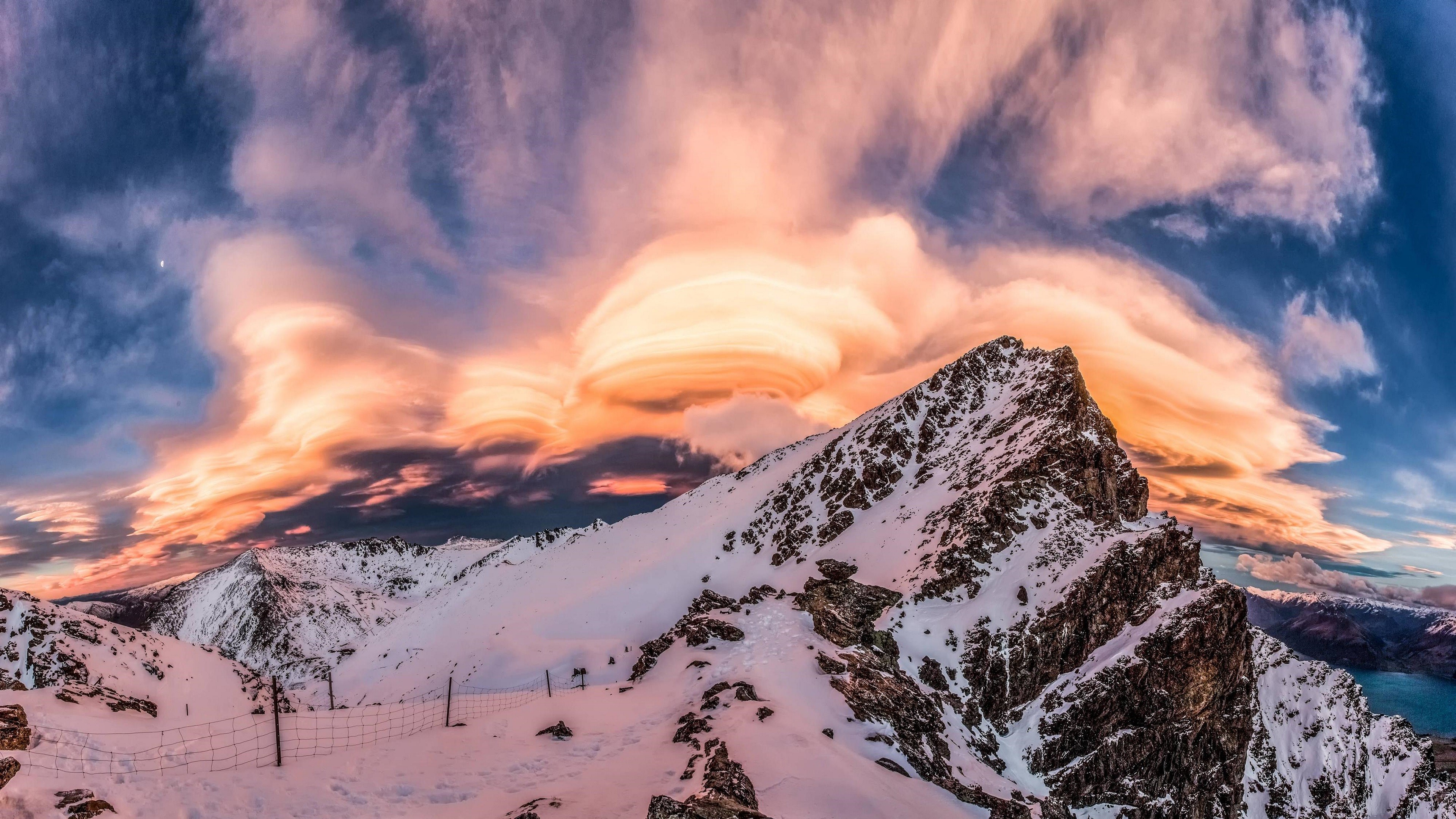 Snowy mountains with lenticular clouds at sunset HD Wallpaper