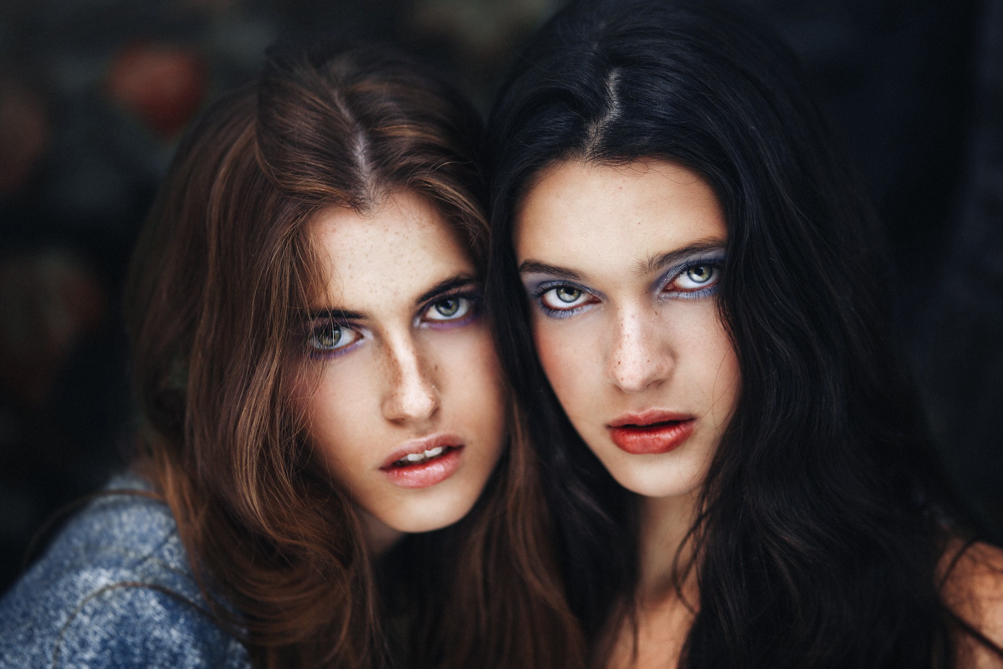Two women with freckles and dramatic makeup HD Wallpaper