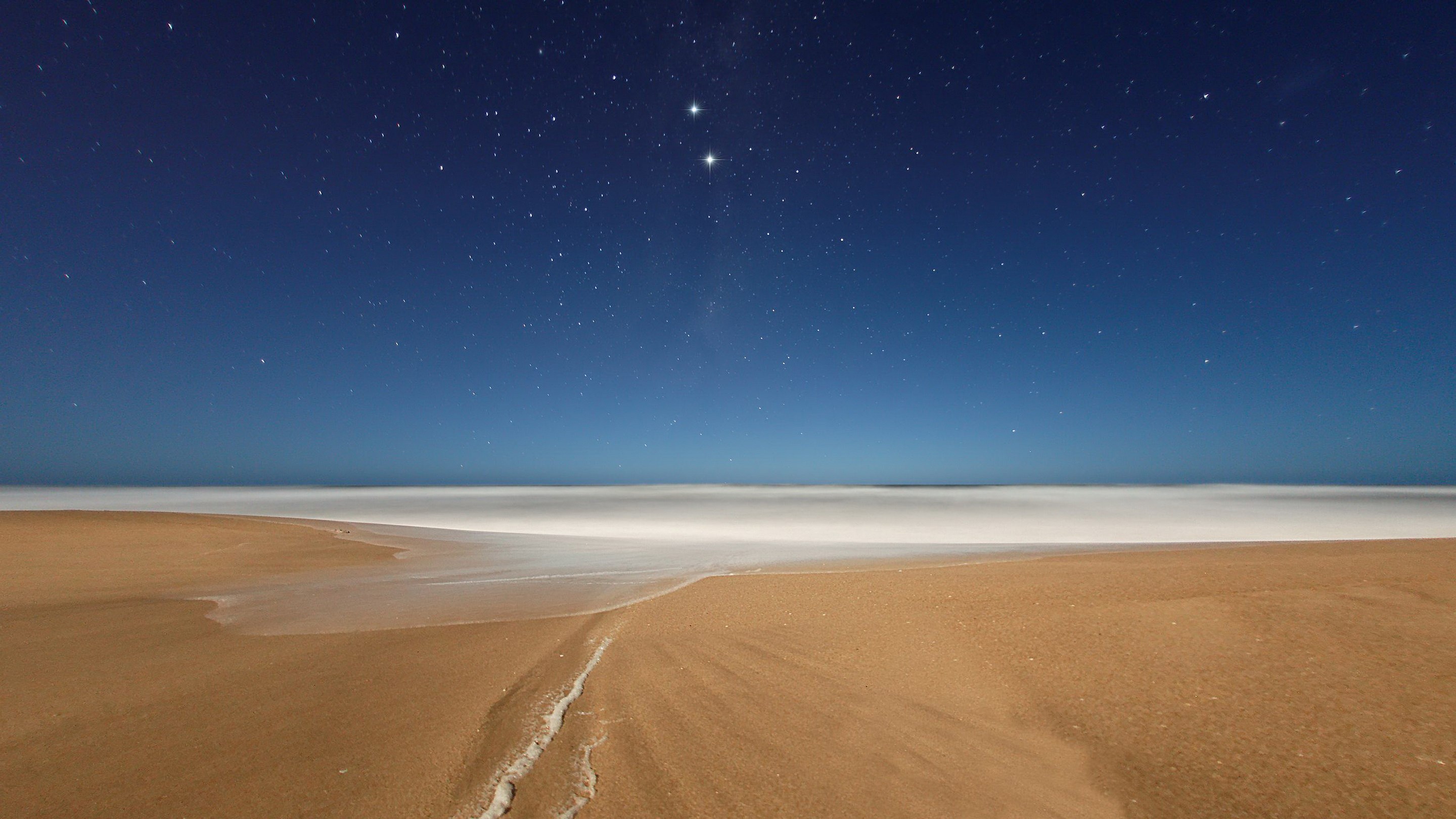 Beach at night with stars and ocean HD Wallpaper