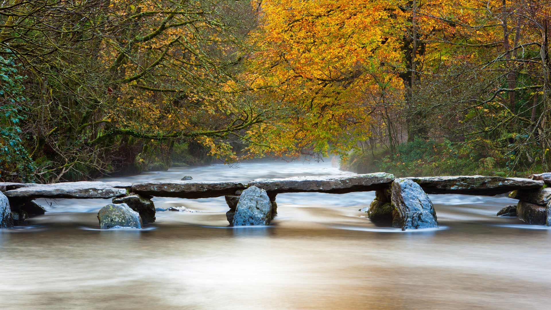 Tarr Steps ancient clapper bridge over a river in autumn HD Wallpaper