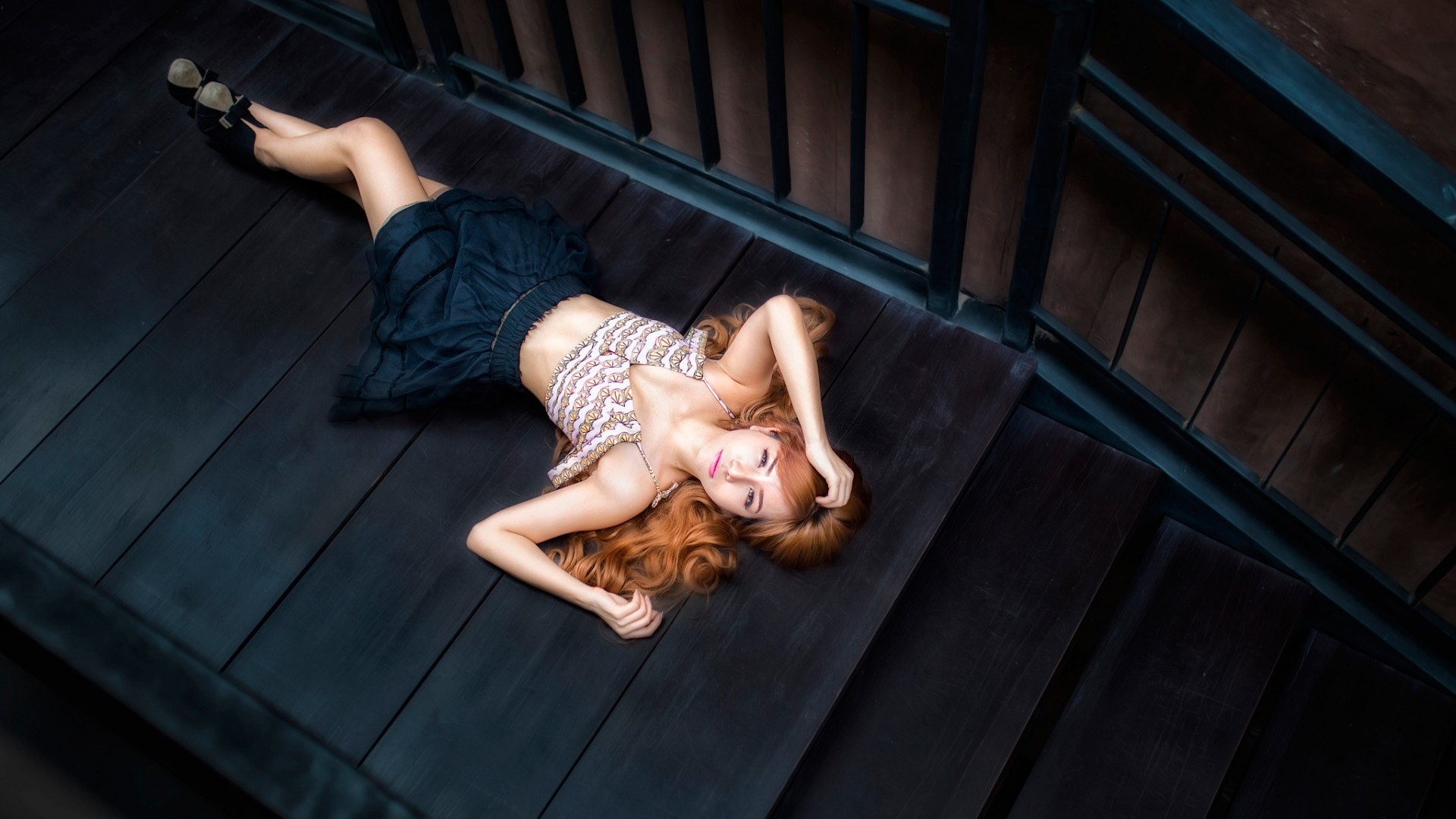 Woman with long red hair lying on wooden stairs HD Wallpaper