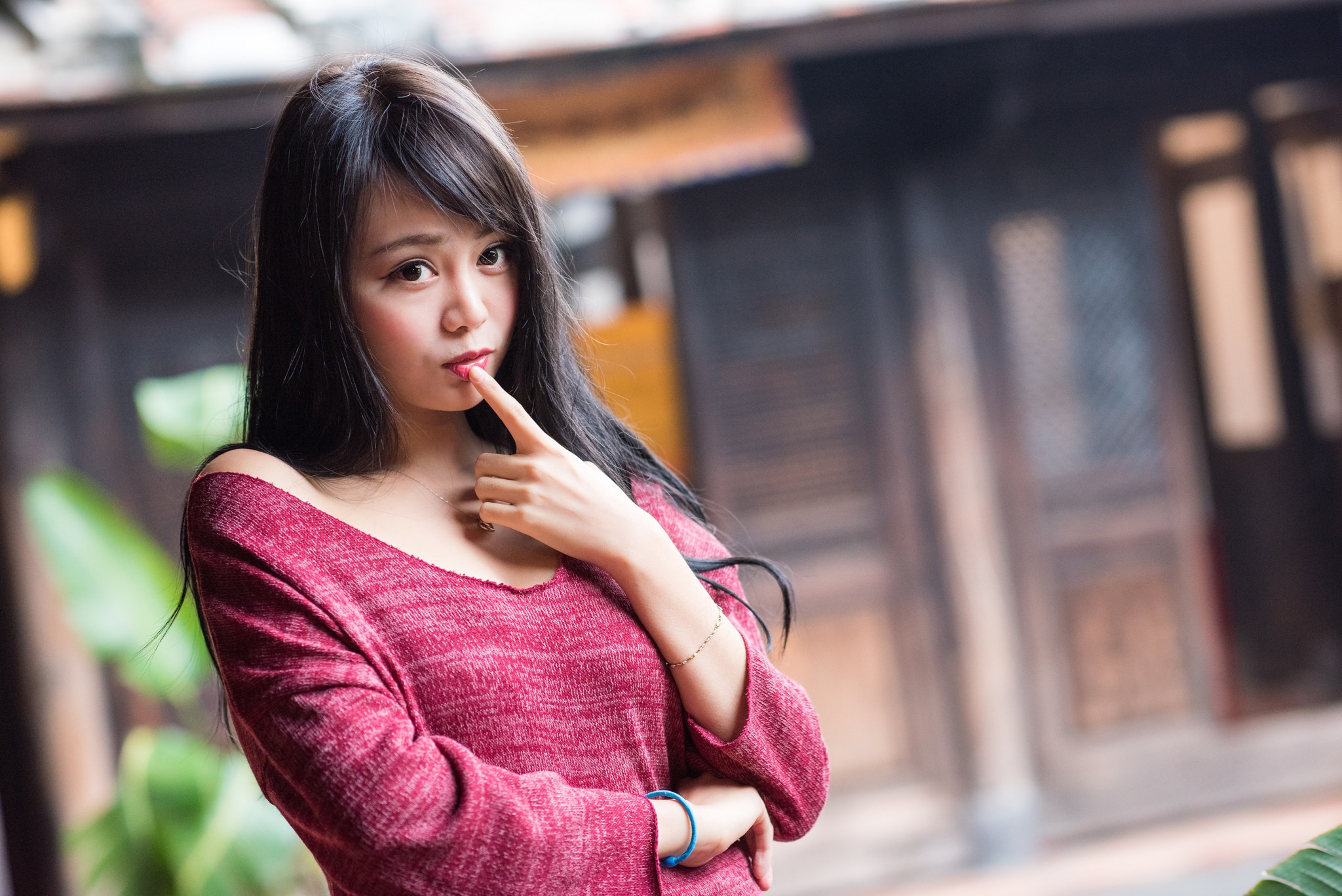 Asian woman with finger on lips HD Wallpaper