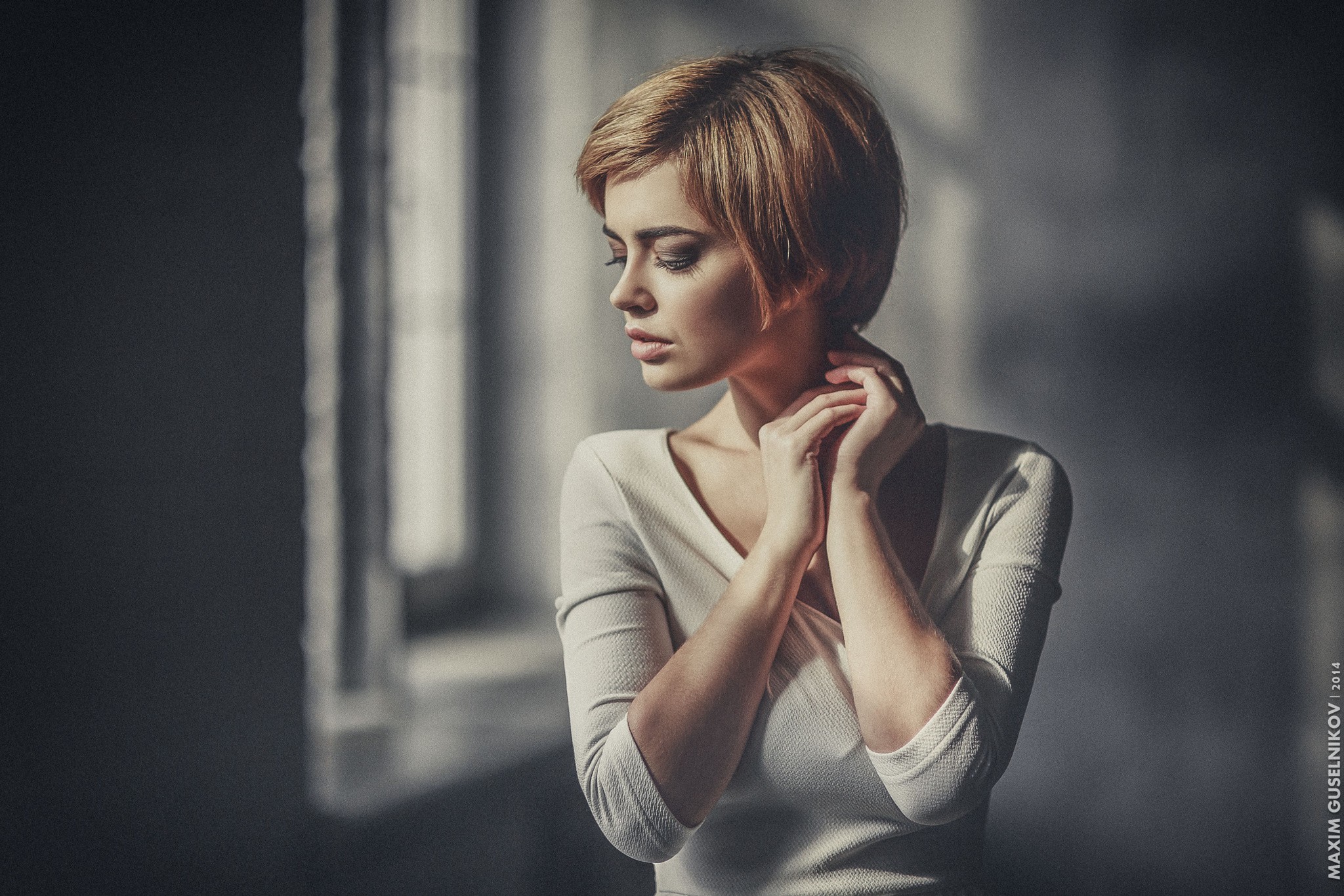 Woman with short blonde hair looking down HD Wallpaper