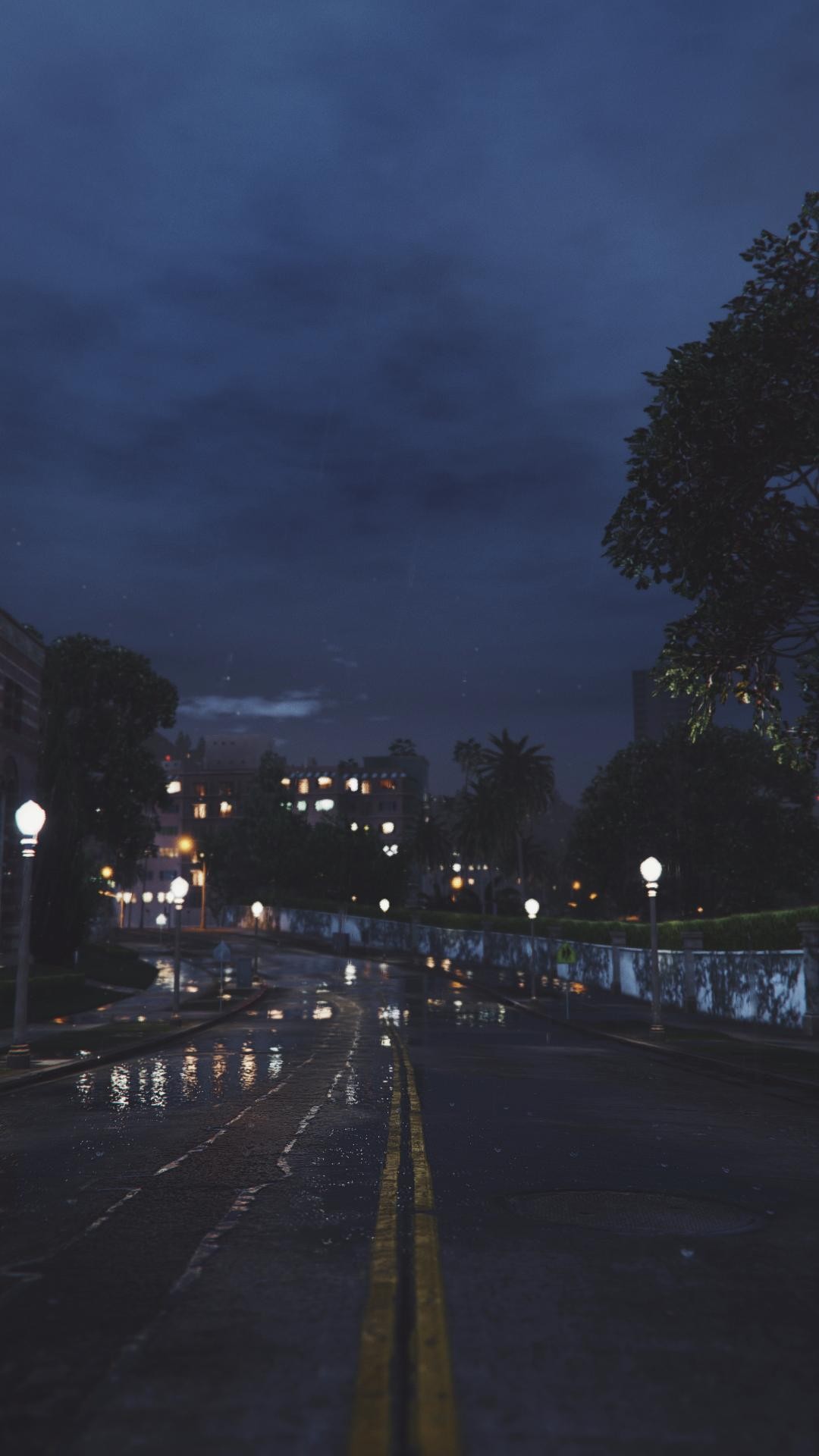 Rainy night road with city lights and dark sky HD Wallpaper