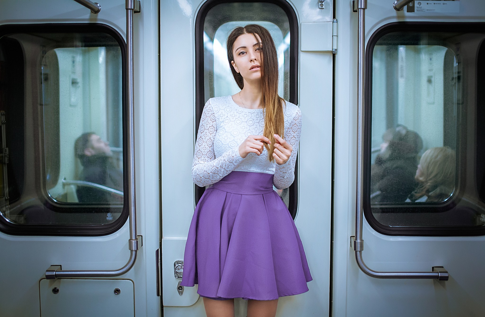 Woman in white top and purple skirt in a subway HD Wallpaper