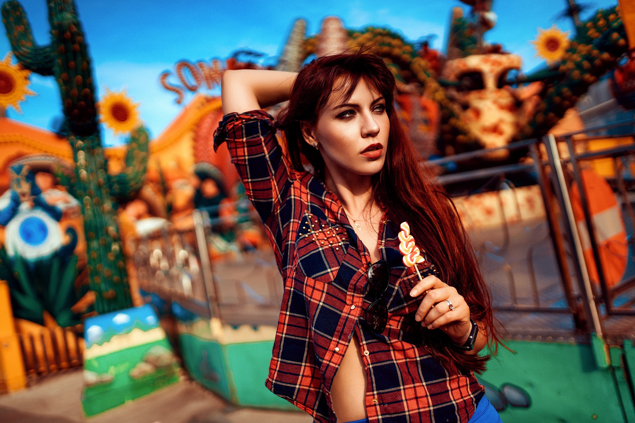 Woman with lollipop at amusement park HD Wallpaper