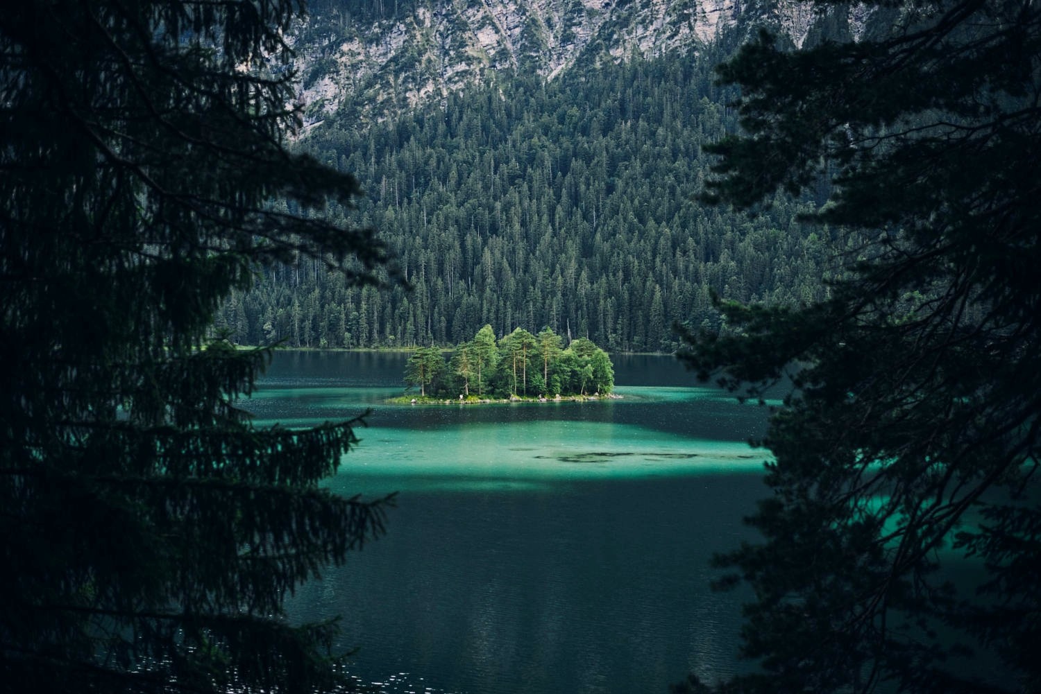 Island in an emerald lake in Germany with mountains HD Wallpaper