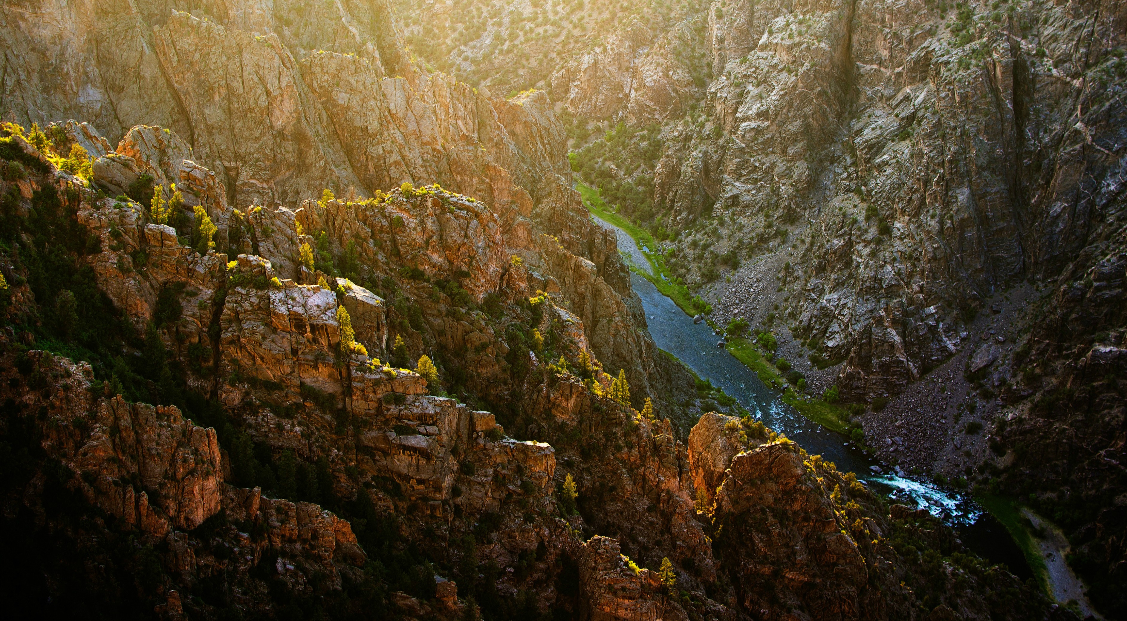 River flowing through a rocky canyon at sunset HD Wallpaper