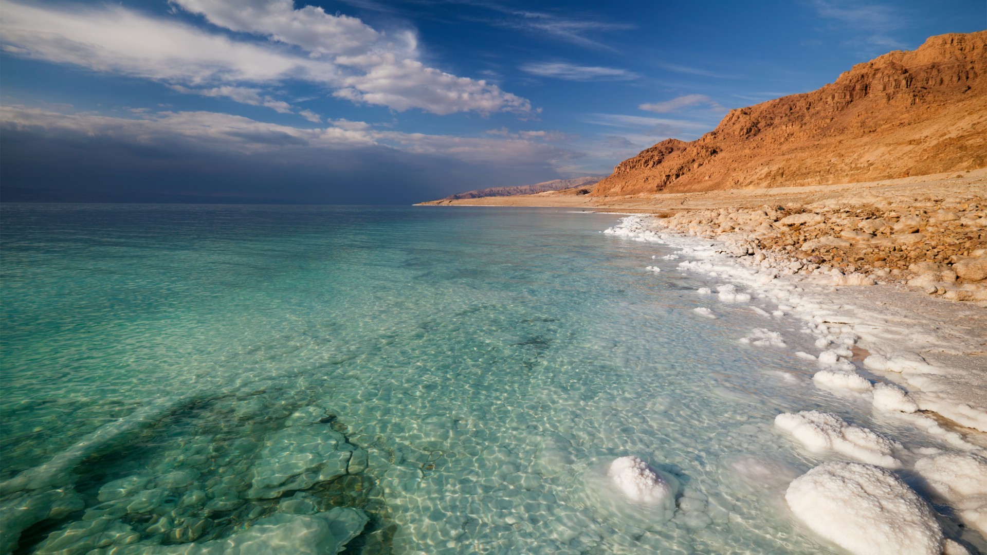 The Dead Sea with salt formations and mountains HD Wallpaper