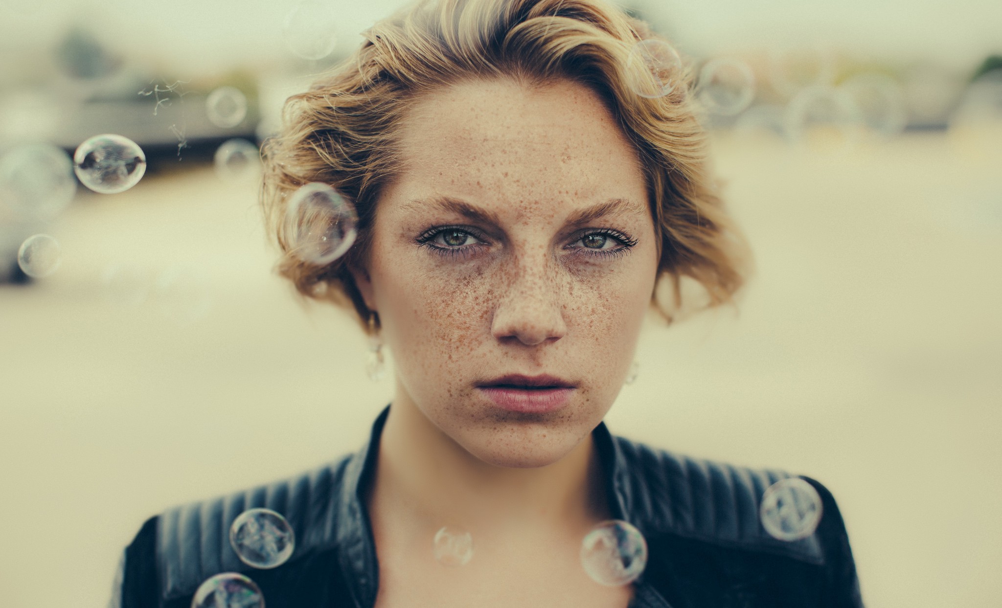 Woman with freckles and blonde wavy hair surrounded by bubbles HD Wallpaper