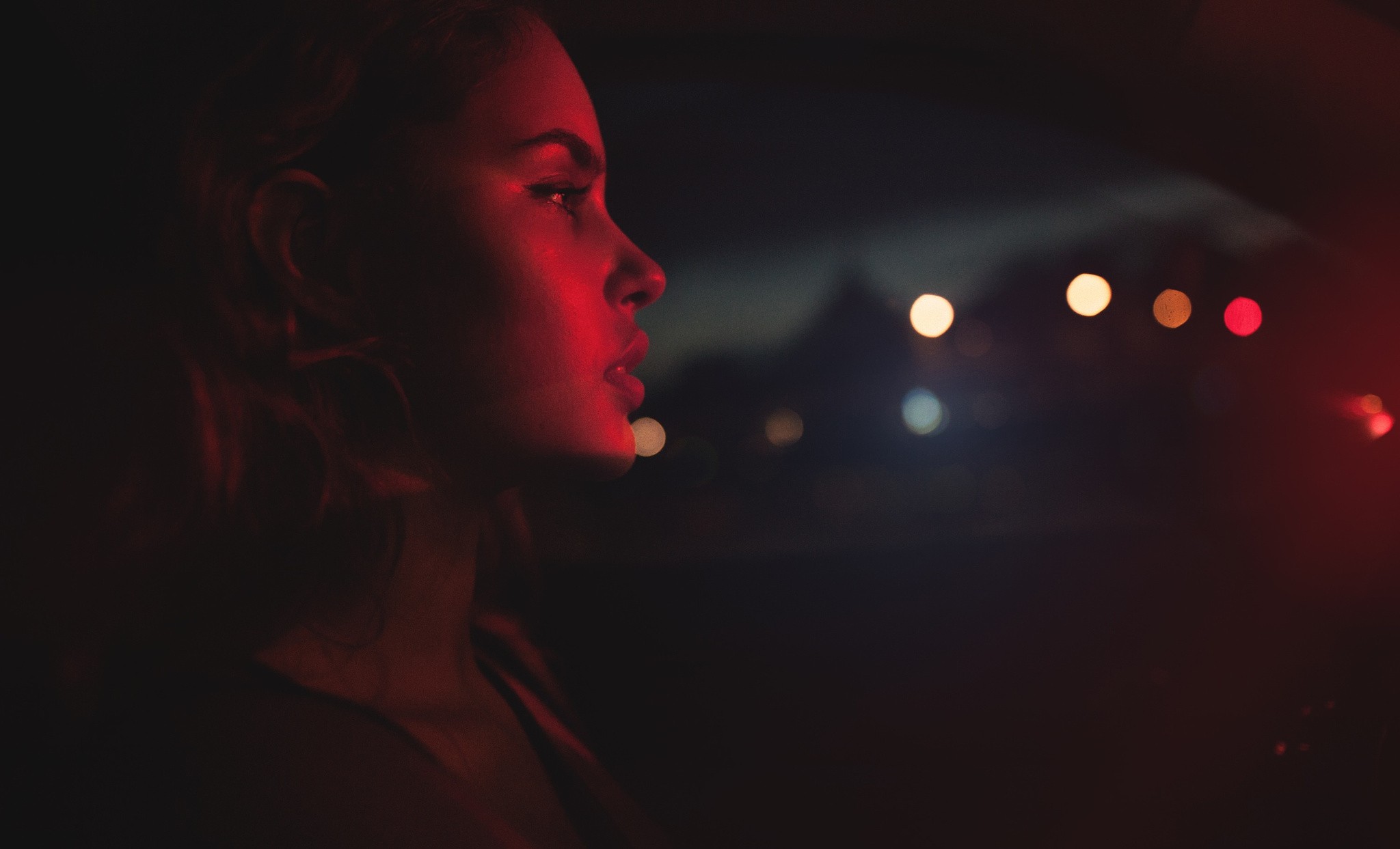 Woman illuminated by red light at night HD Wallpaper