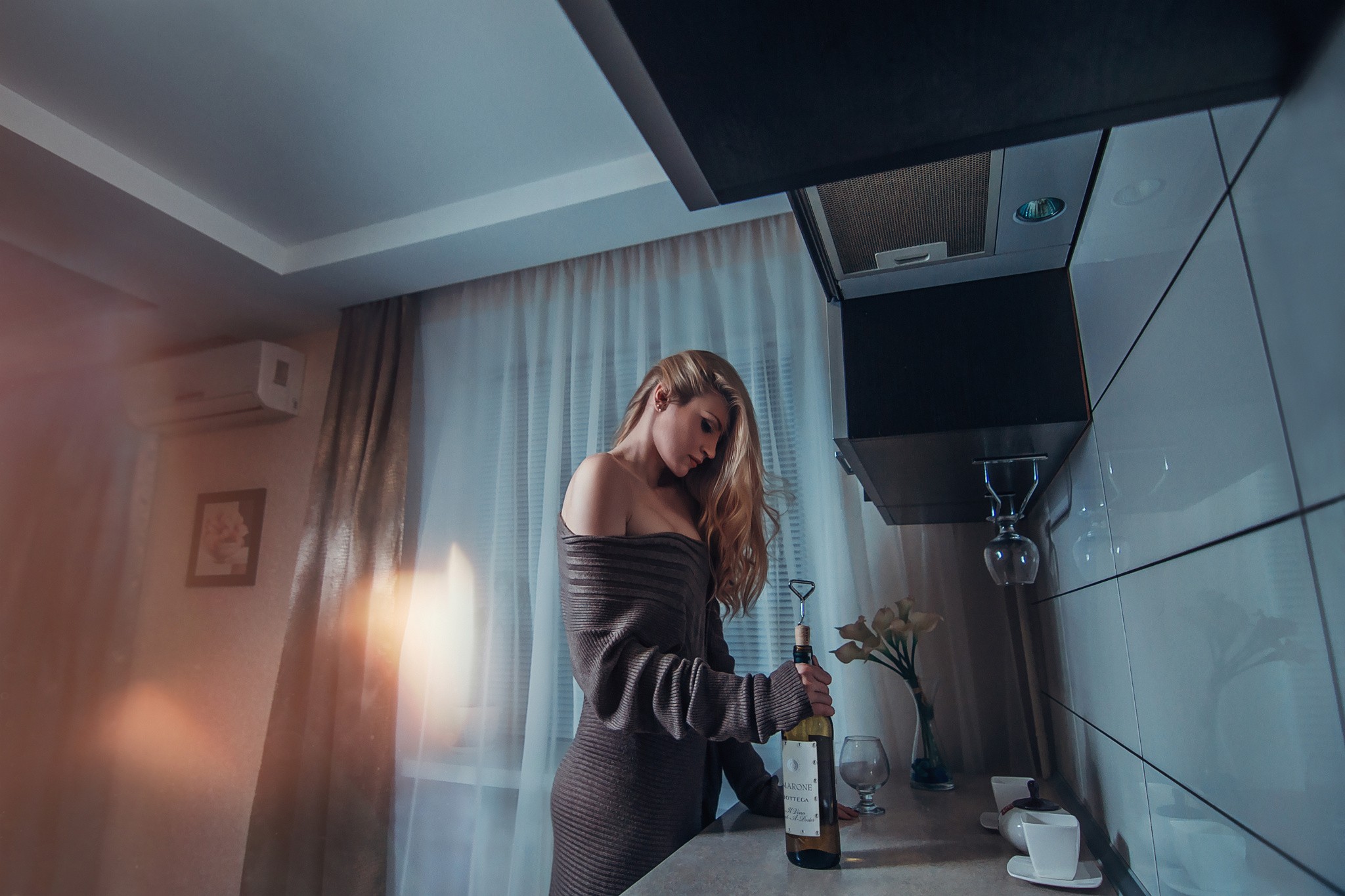 Woman opening a bottle of wine in the kitchen HD Wallpaper