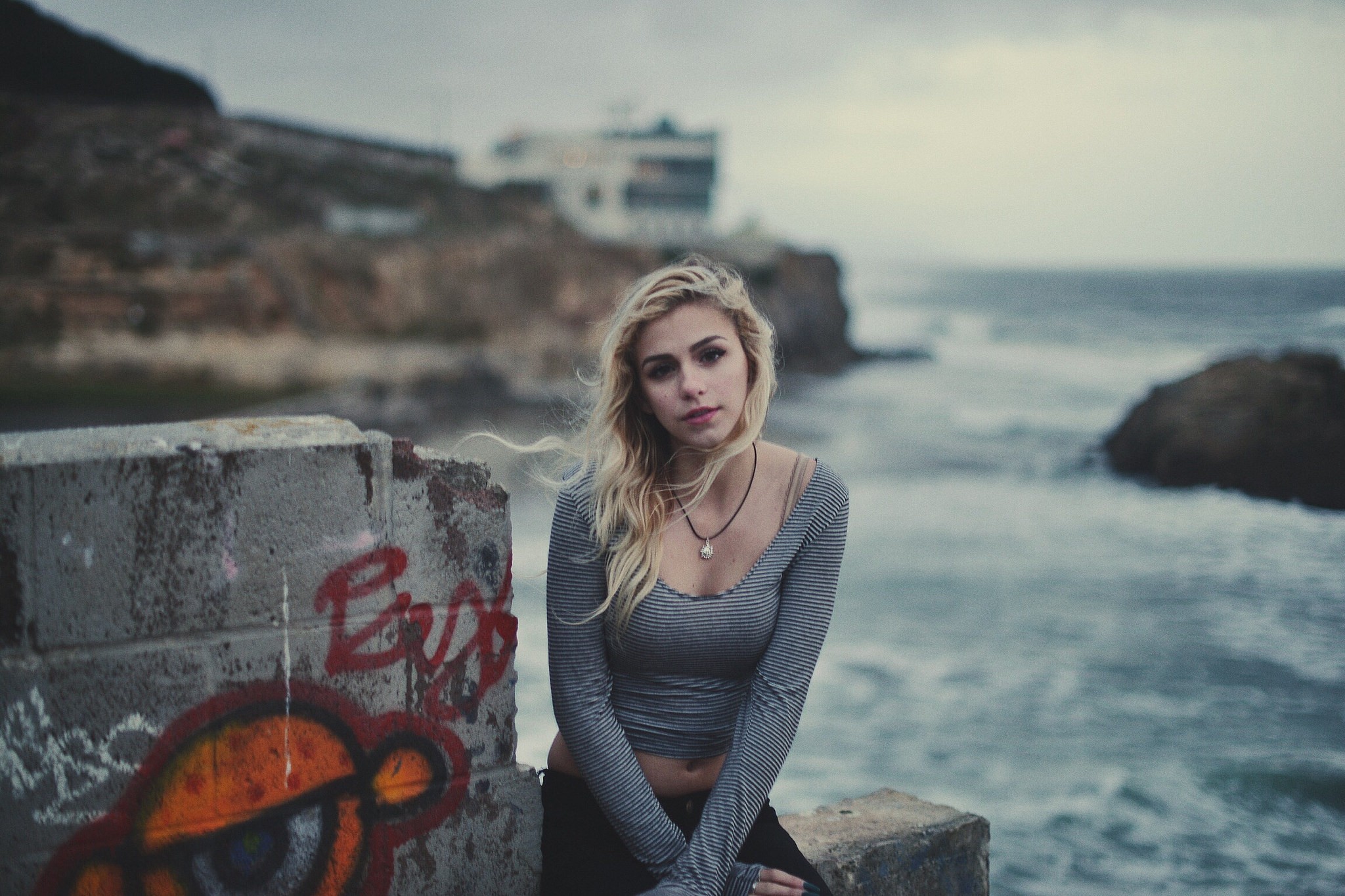 Woman with blonde hair sitting by the water HD Wallpaper