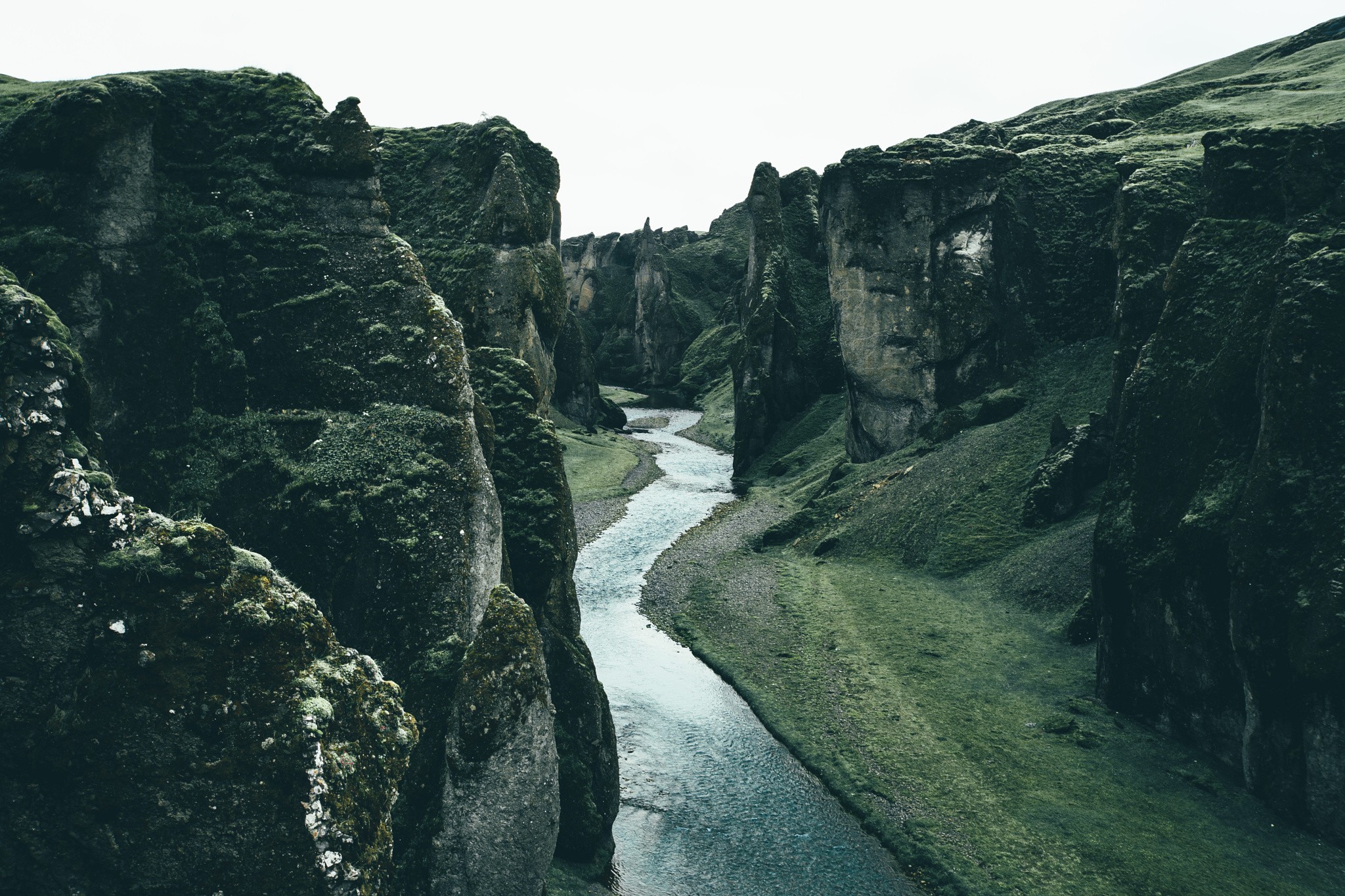 River flowing through a moss-covered canyon HD Wallpaper