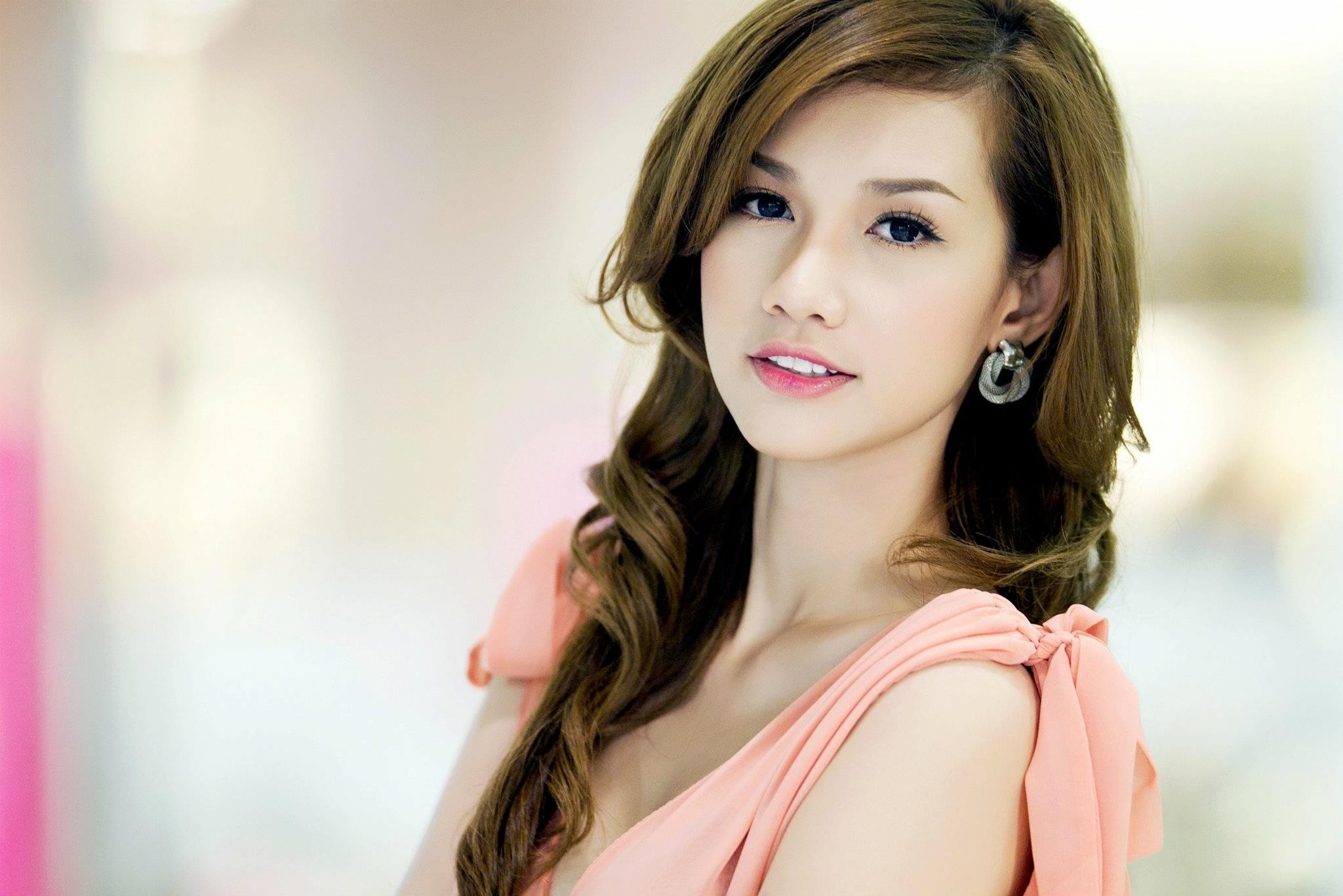 Portrait of an Asian woman with wavy brown hair HD Wallpaper