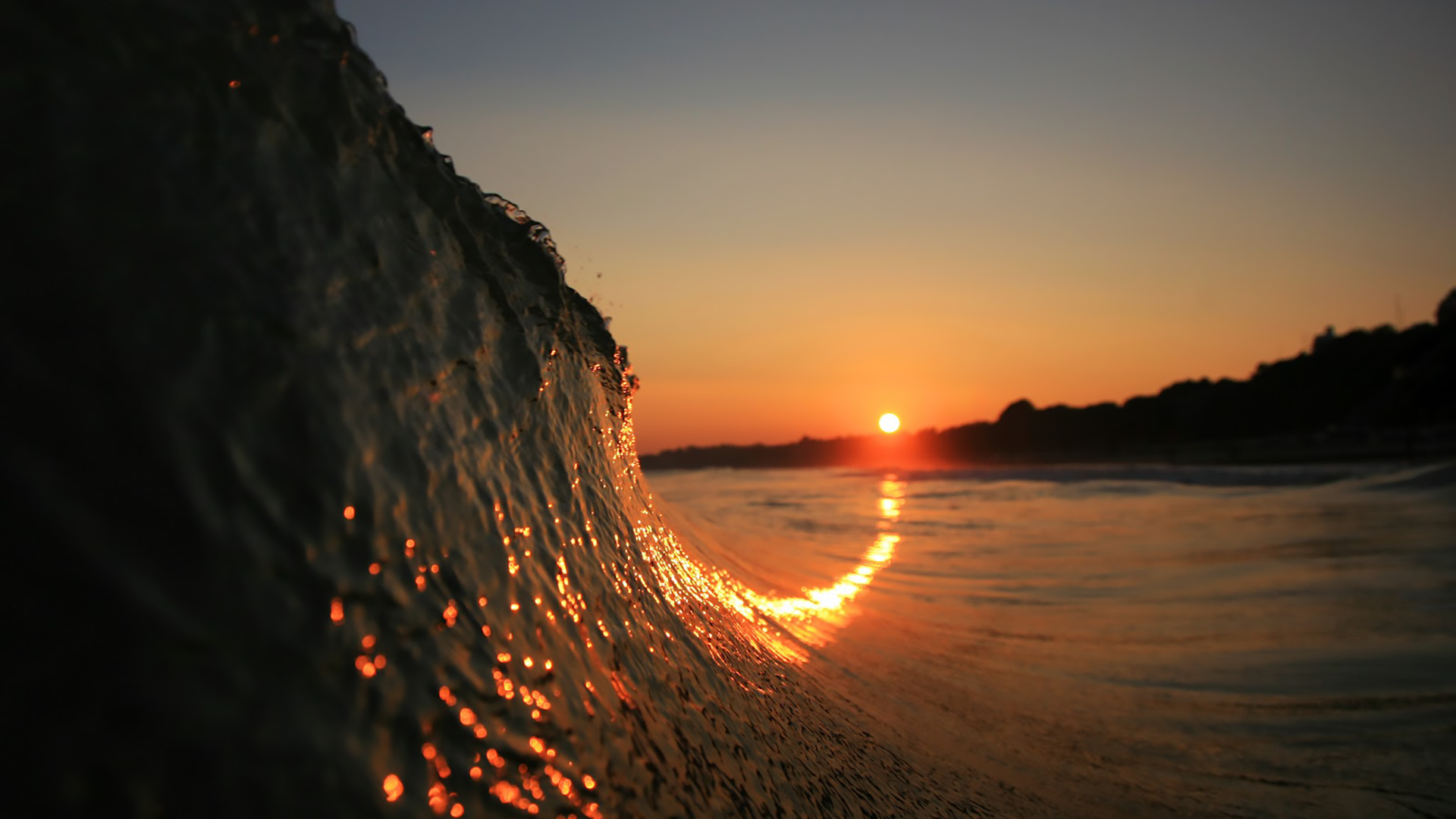 Wave crashing at sunset with depth of field HD Wallpaper