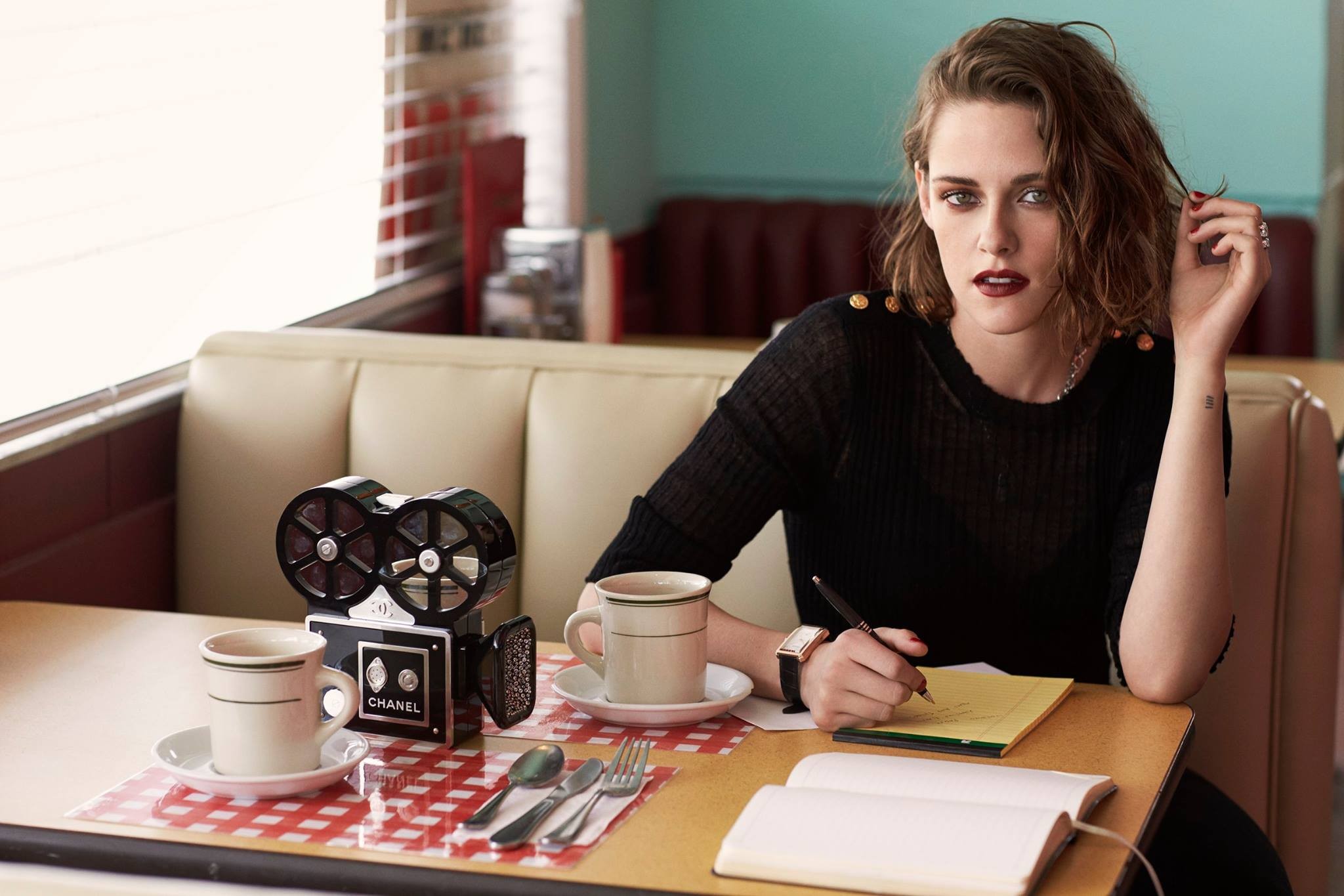 cup, long hair, Chanel, table, women, open mouth, see-through clothing, brunette, camera, sitting, pens, actress, Kristen Stewart, celebrity, coffee, watch, cafeteria , writing, books, black dress, looking at viewer HD Wallpaper