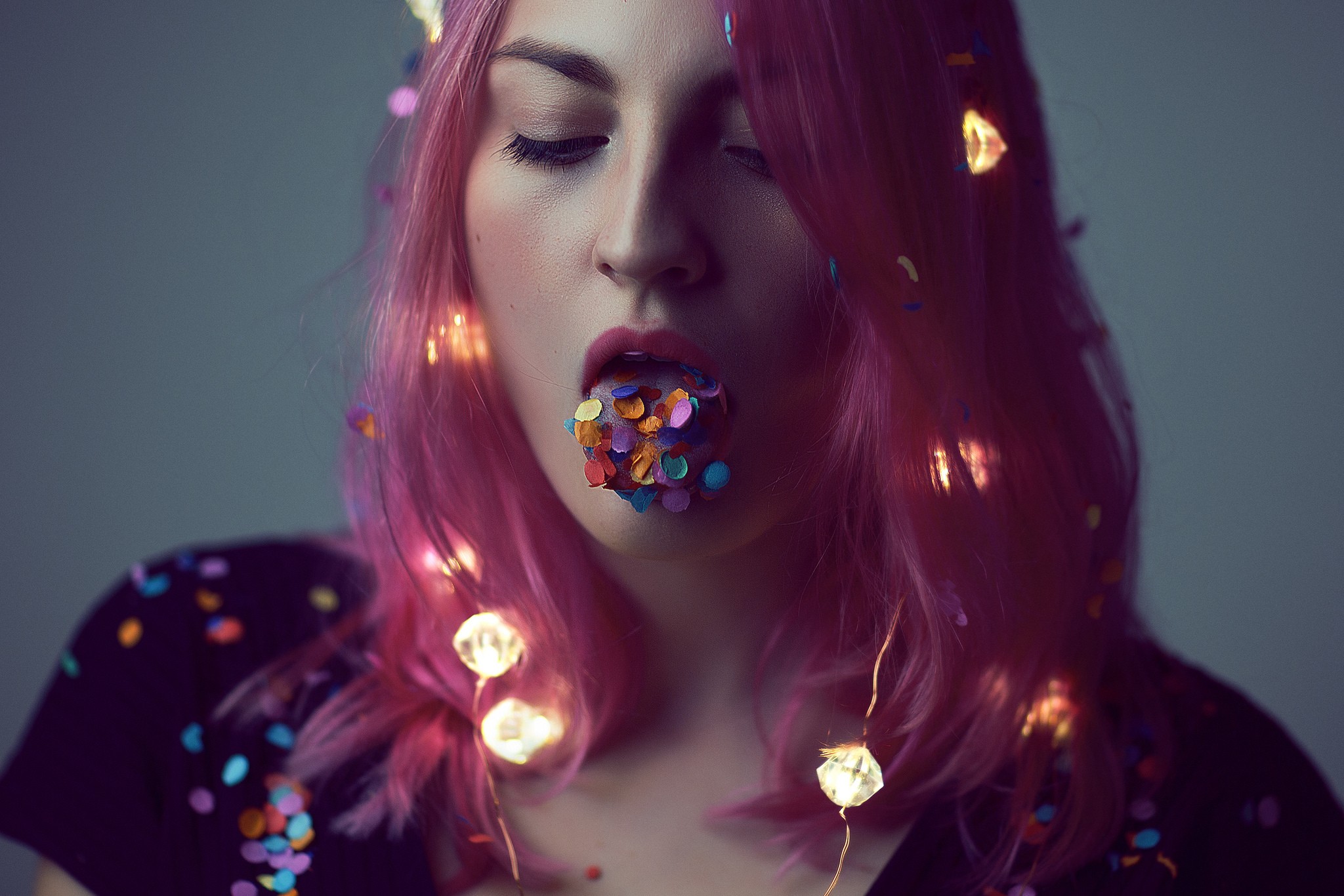 Woman with pink hair and confetti in mouth HD Wallpaper