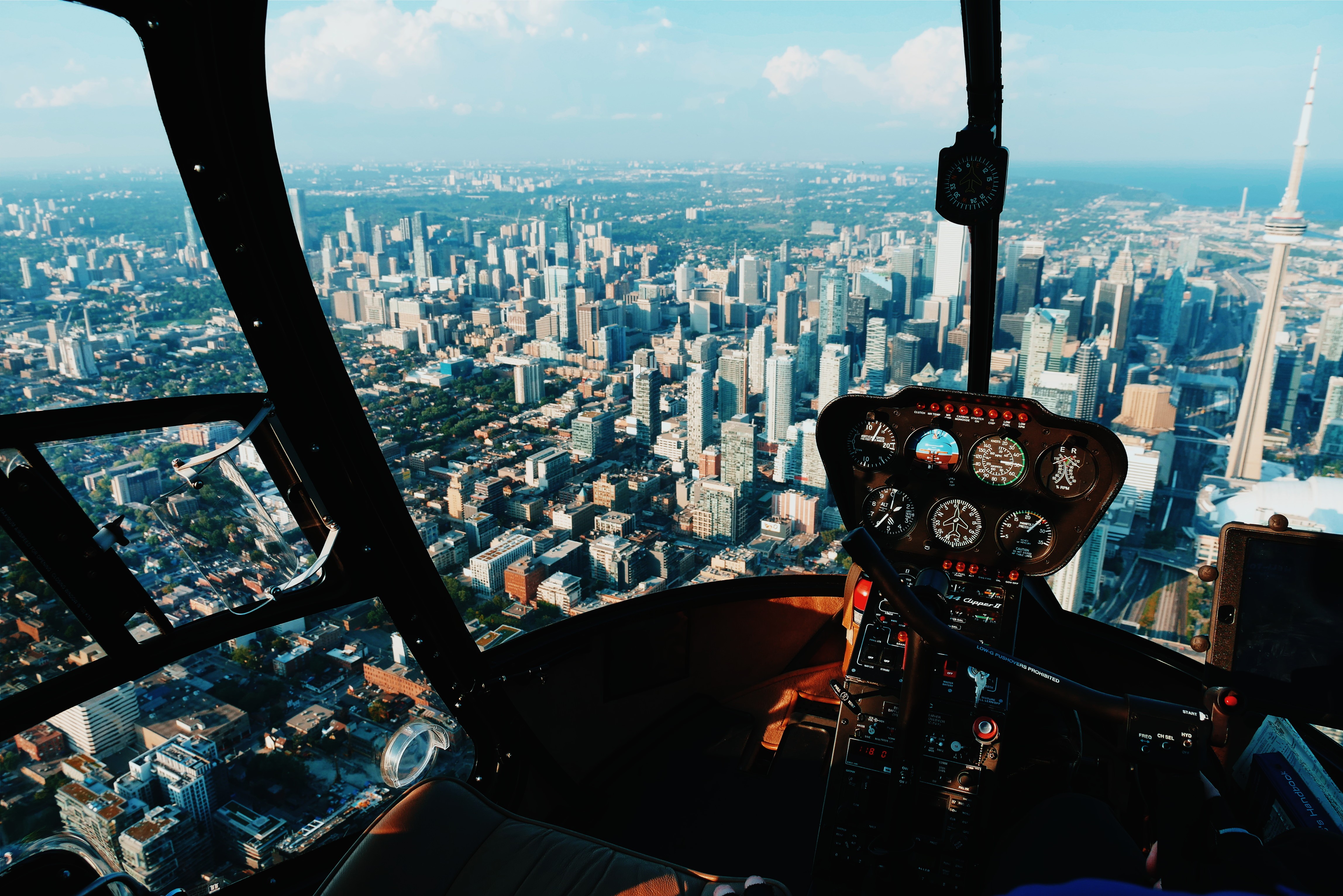 Helicopter cockpit view of Toronto cityscape with CN Tower HD Wallpaper