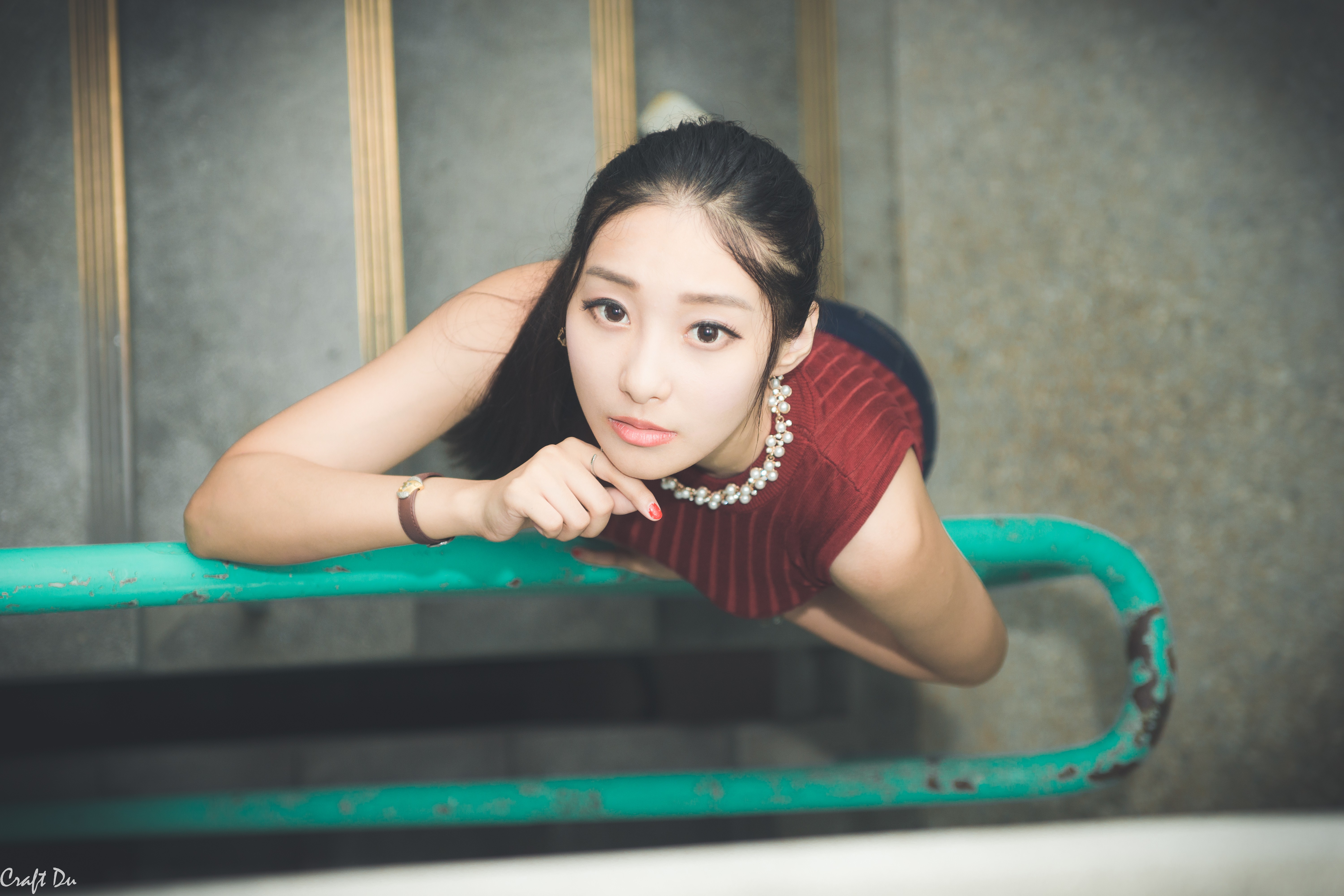 Asian woman with pearl necklace on stairs HD Wallpaper