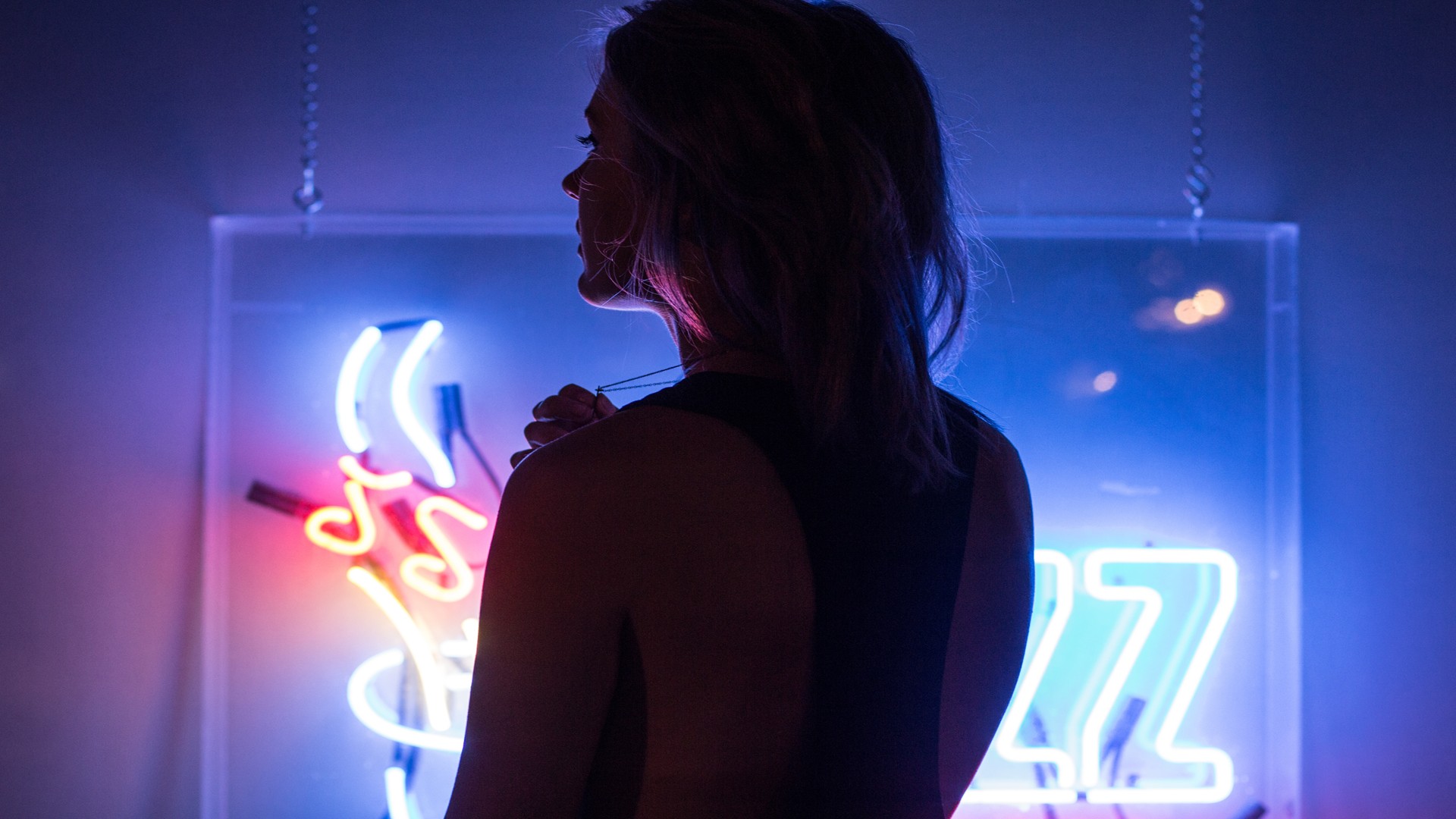 Woman in front of neon sign HD Wallpaper