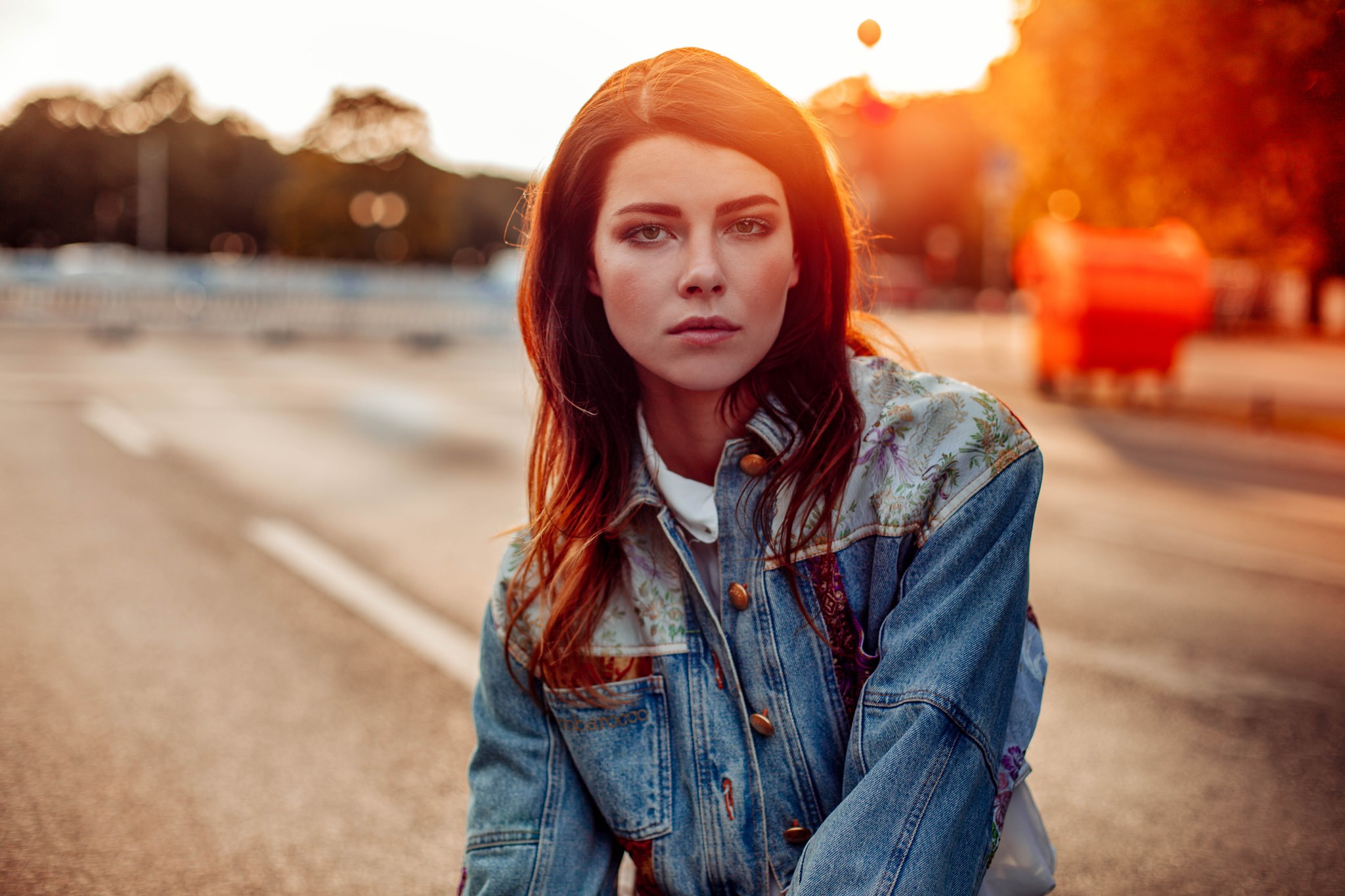 Woman in denim jacket on a road at sunset HD Wallpaper