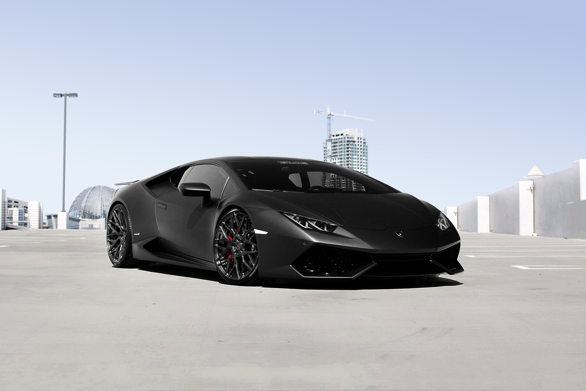 Matte black Lamborghini Huracan in a parking lot HD Wallpaper